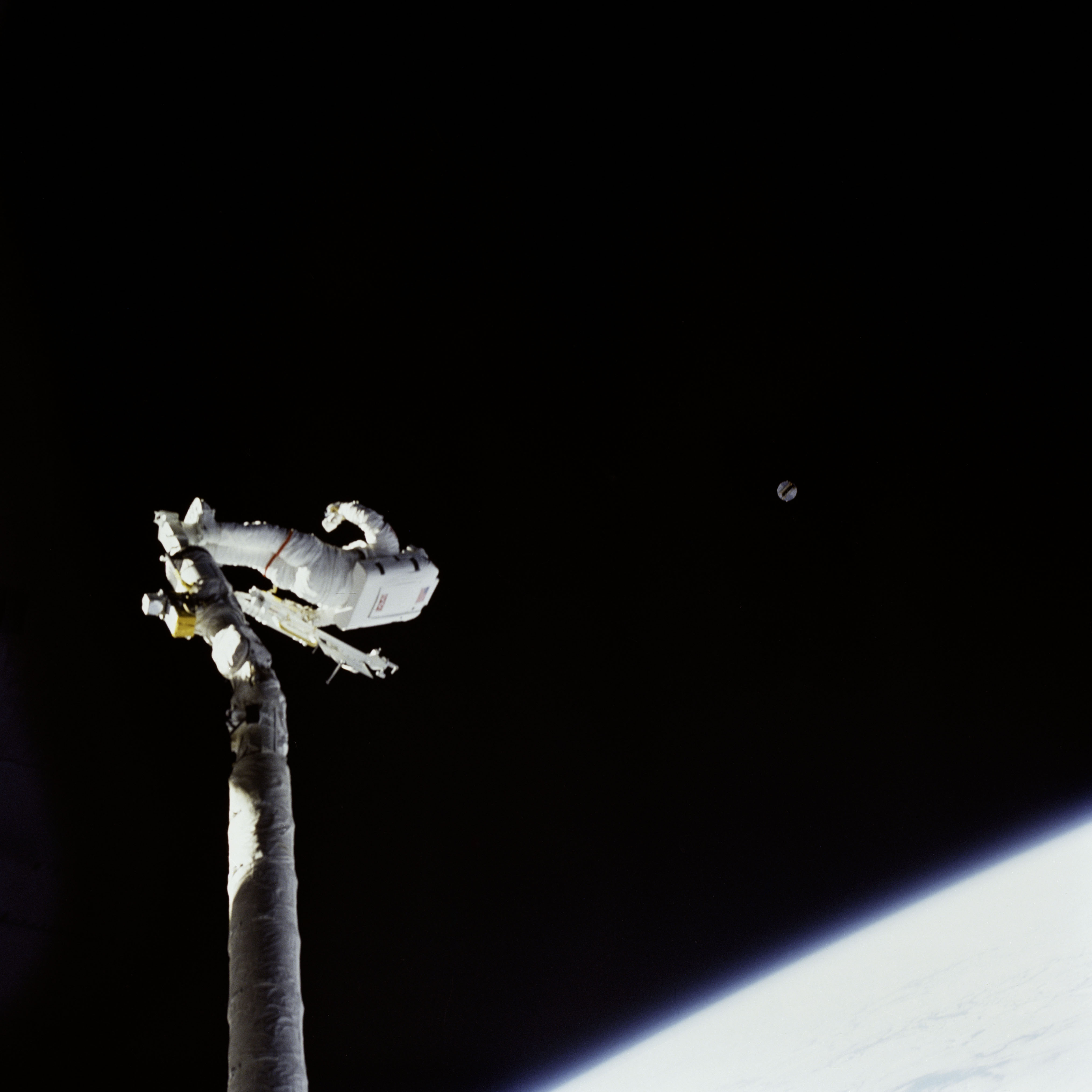 Astronaut James van Hoften on RMS tracking Syncom IV-3 after deployment