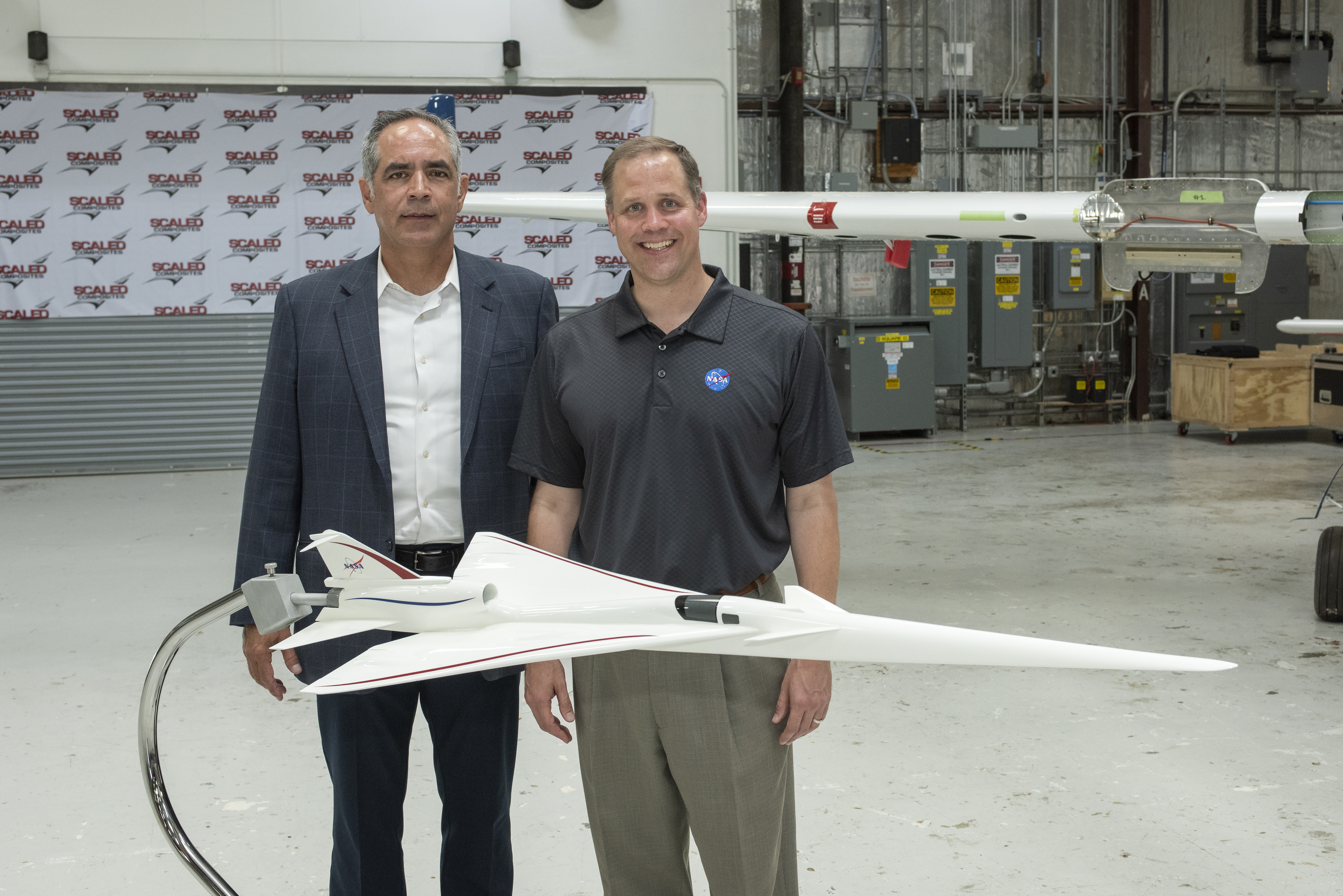 NASA Administrator Bridenstine and Armstrong Flight Research Center's Center Director McBride stand beside model of NASA's Supersonic X-Plane, X-59 Quiet Supersonic Technology or QueSST at press event in Mojave Air & Space Port in California