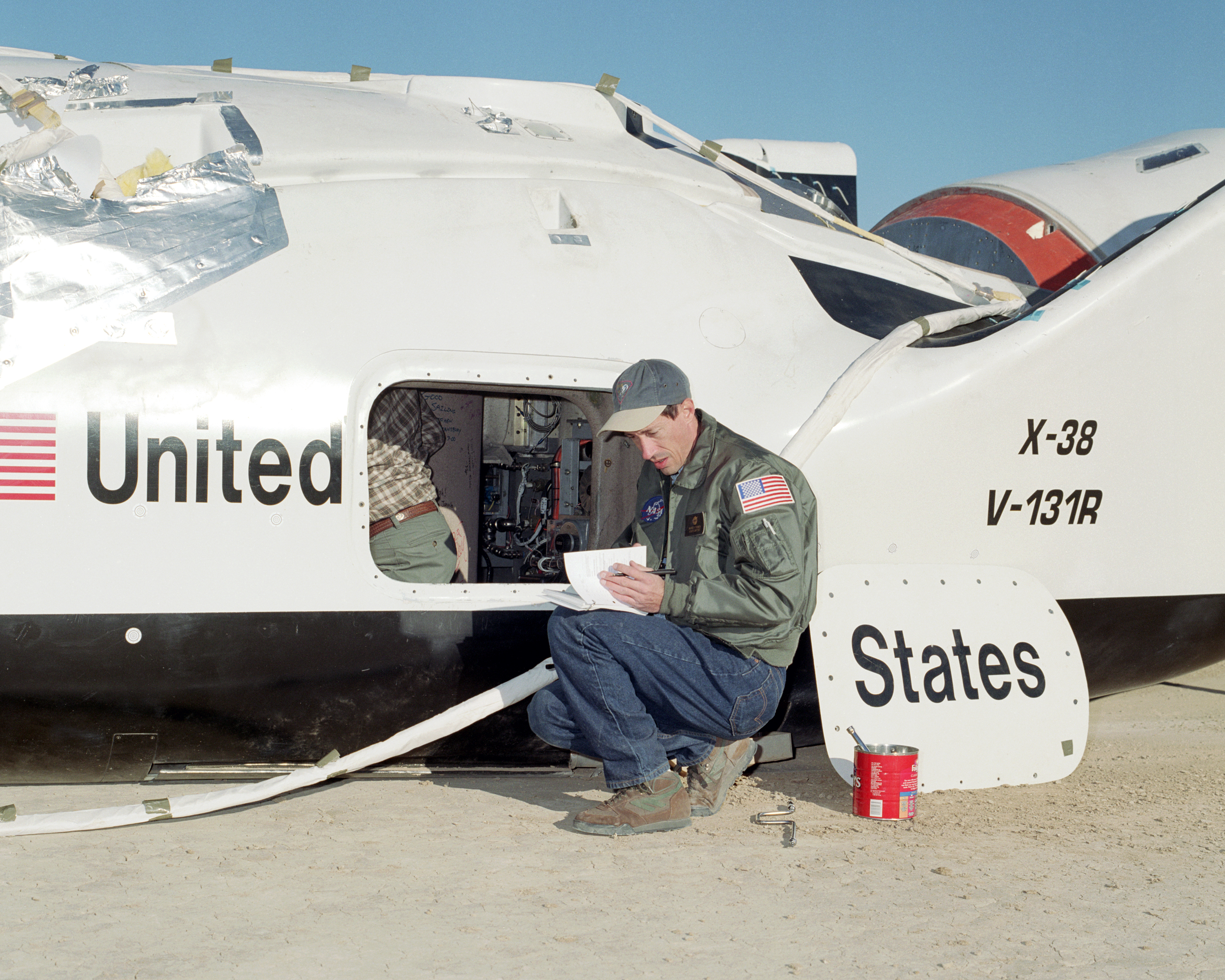 NASA engineer Wayne Peterson from the Johnson Space Center reviews postflight checklists following a spectacular flight of the X-38 Vehicle 131R