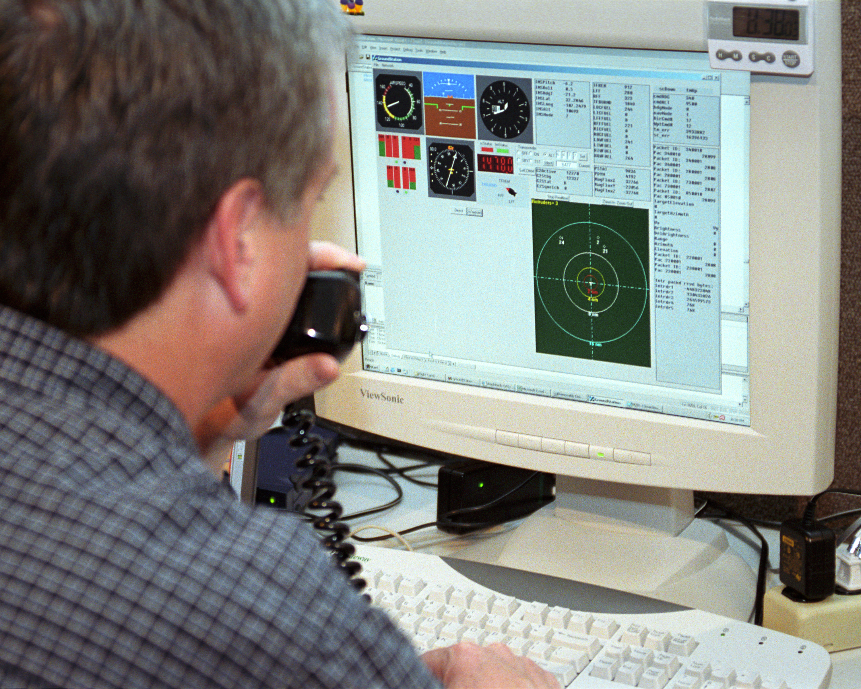 Scaled Composites' Doug Shane examines the screen of his ground control station during tests in New Mexico. Shane used this configuration as the ground control station to remotely pilot the Proteus aircraft during a NASA sponsored series of tests.