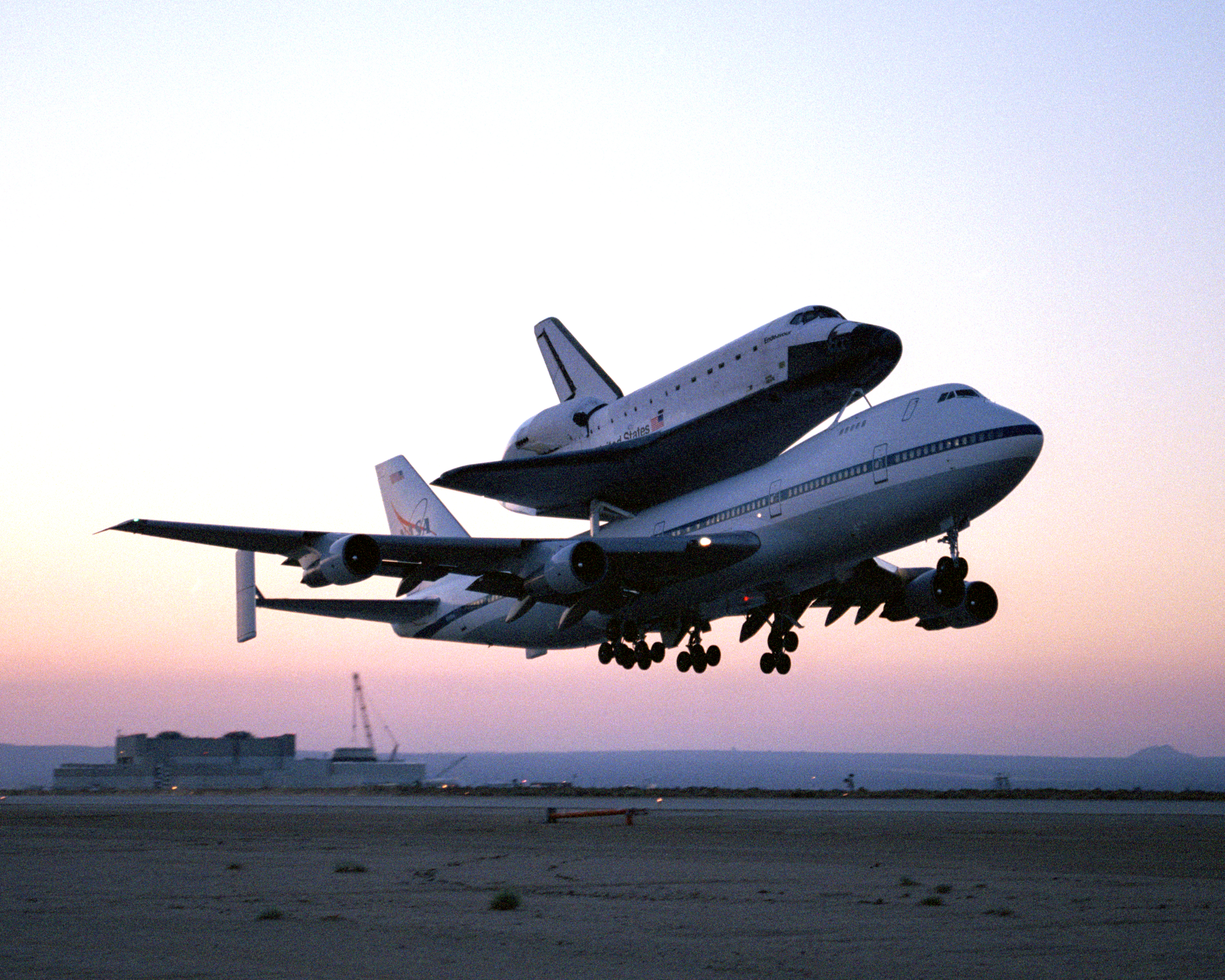 The Space Shuttle Endeavour, mounted securely atop one of NASA's modified Boeing 747 Shuttle Carrier Aircraft, left NASA's Dryden Flight Research Center at Edwards Air Force Base in Southern California at sunrise on Friday, June 28