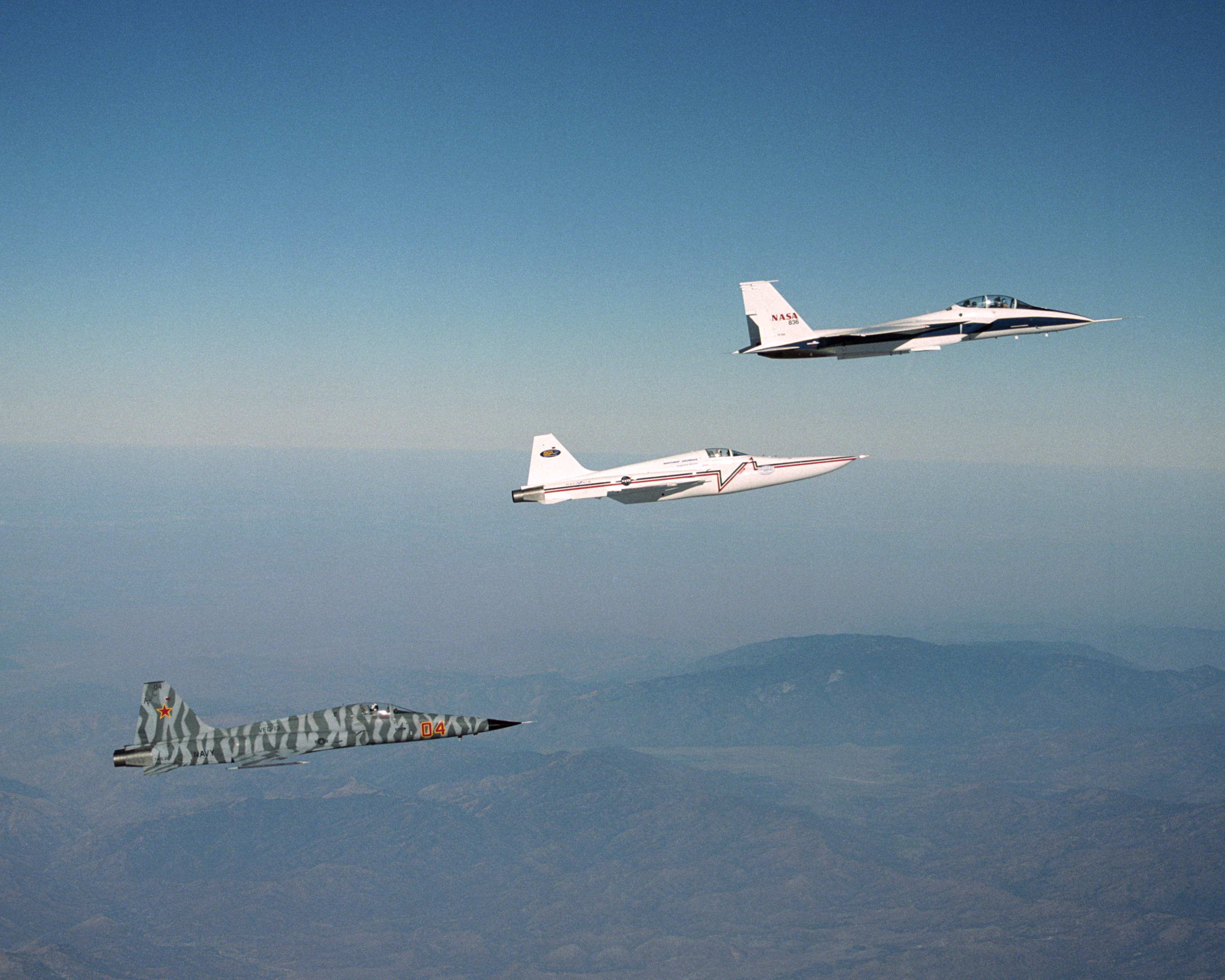 Northrop Grumman Corp.'s modified F-5E Shaped Sonic Boom Demonstration (SSBD) aircraft flies off the wing of NASA's F-15B Research testbed aircraft.