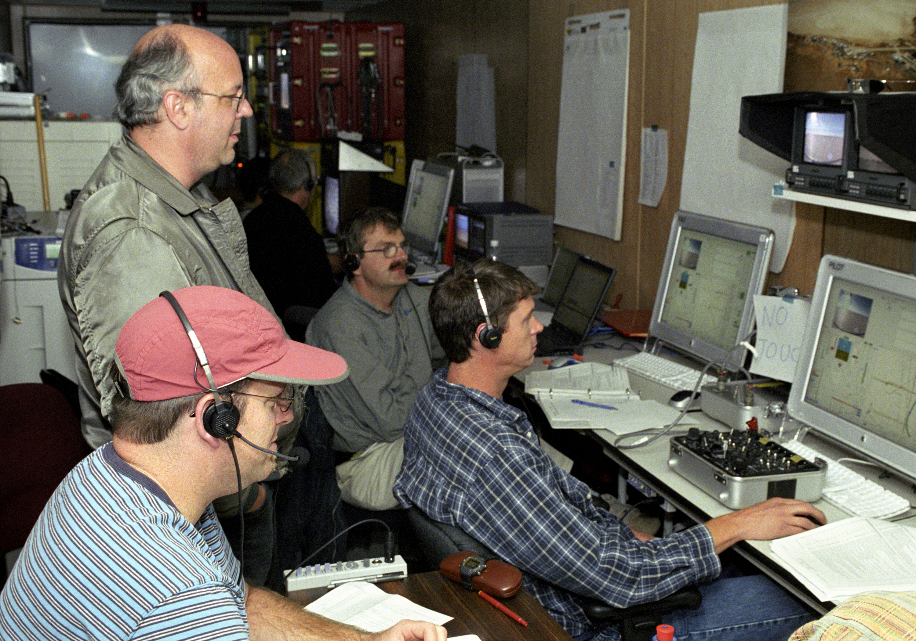 AeroVironment's Jim Daley, Rik Meininger, Derek Lisoski and Wyatt Sadler (clockwise from bottom left) closely monitor systems testing of the Pathfinder-Plus.