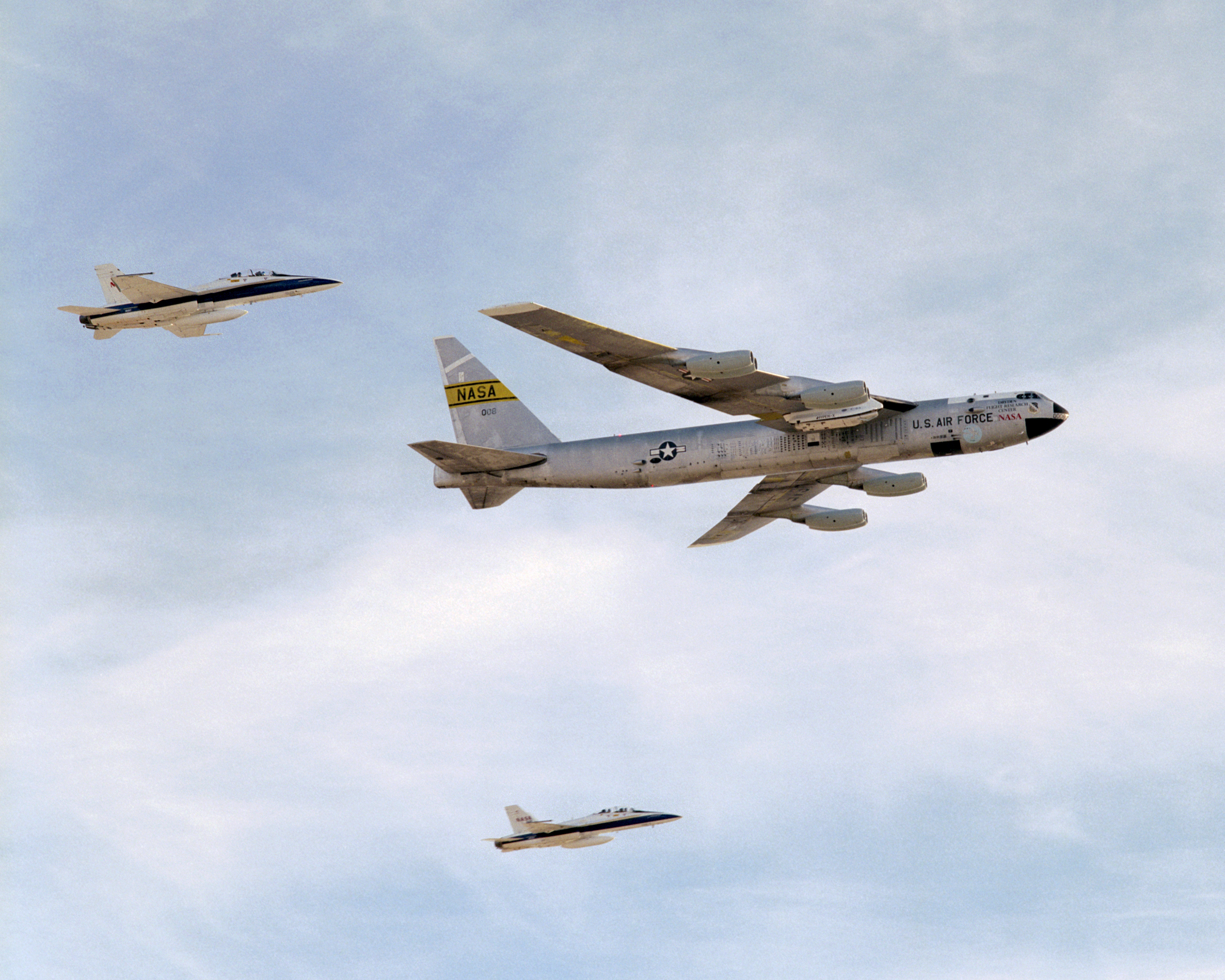 NASA's B-52B mothership, escorted by two F-18s, makes a final flyover after its last research mission that launched the X-43A on its record Mach 9.6 flight