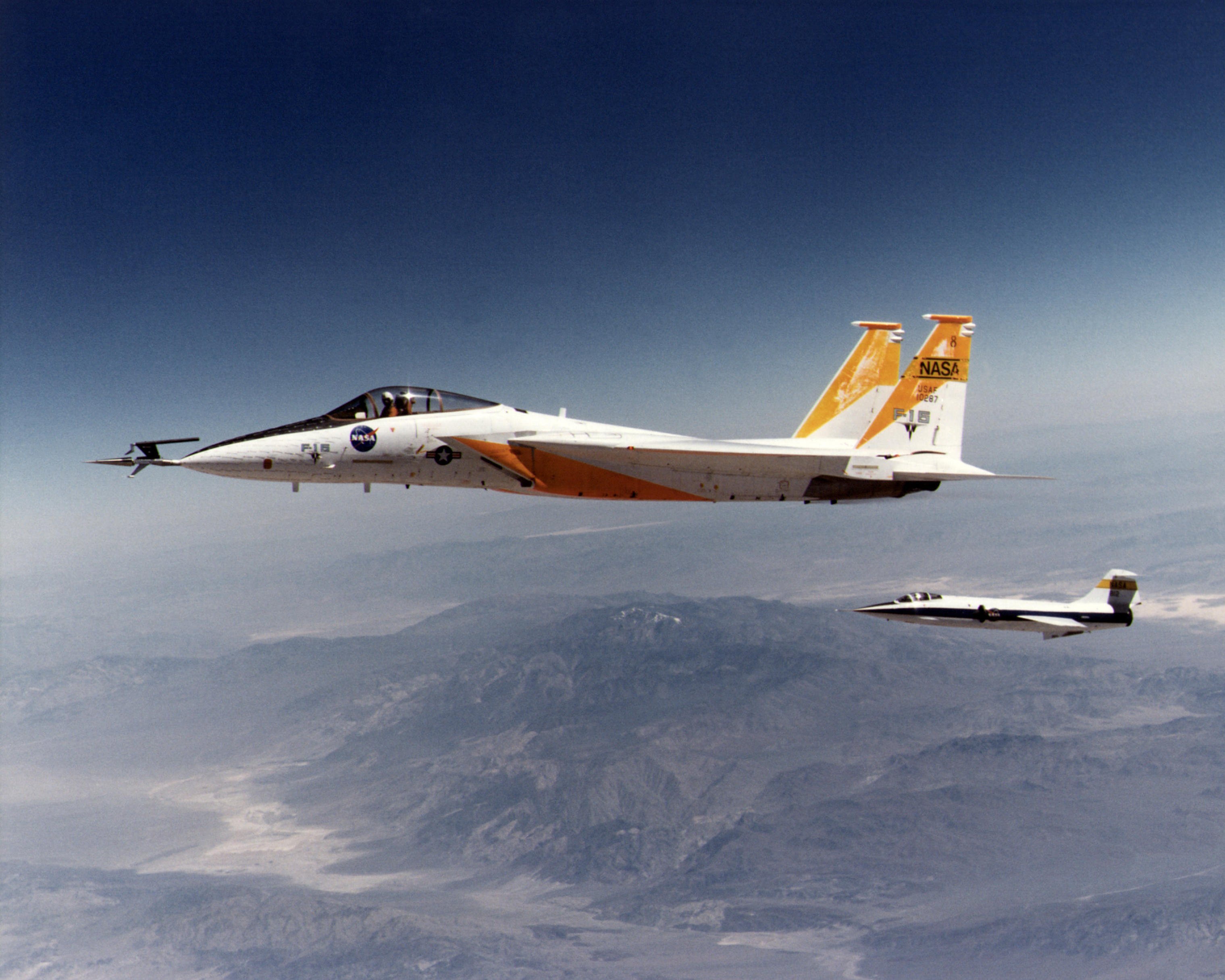 F-15A in flight with 10 degree cone experiment and F-104N chase