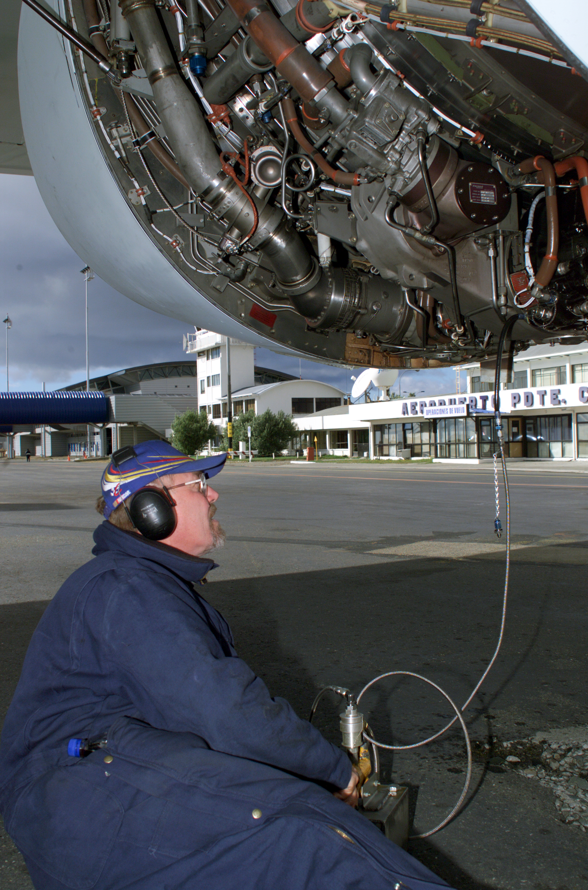 NASA DC-8 Ground Support Technician Joe Niquette performs routine maintenance on the DC-8 aircraft in Punta Arenas, Chile