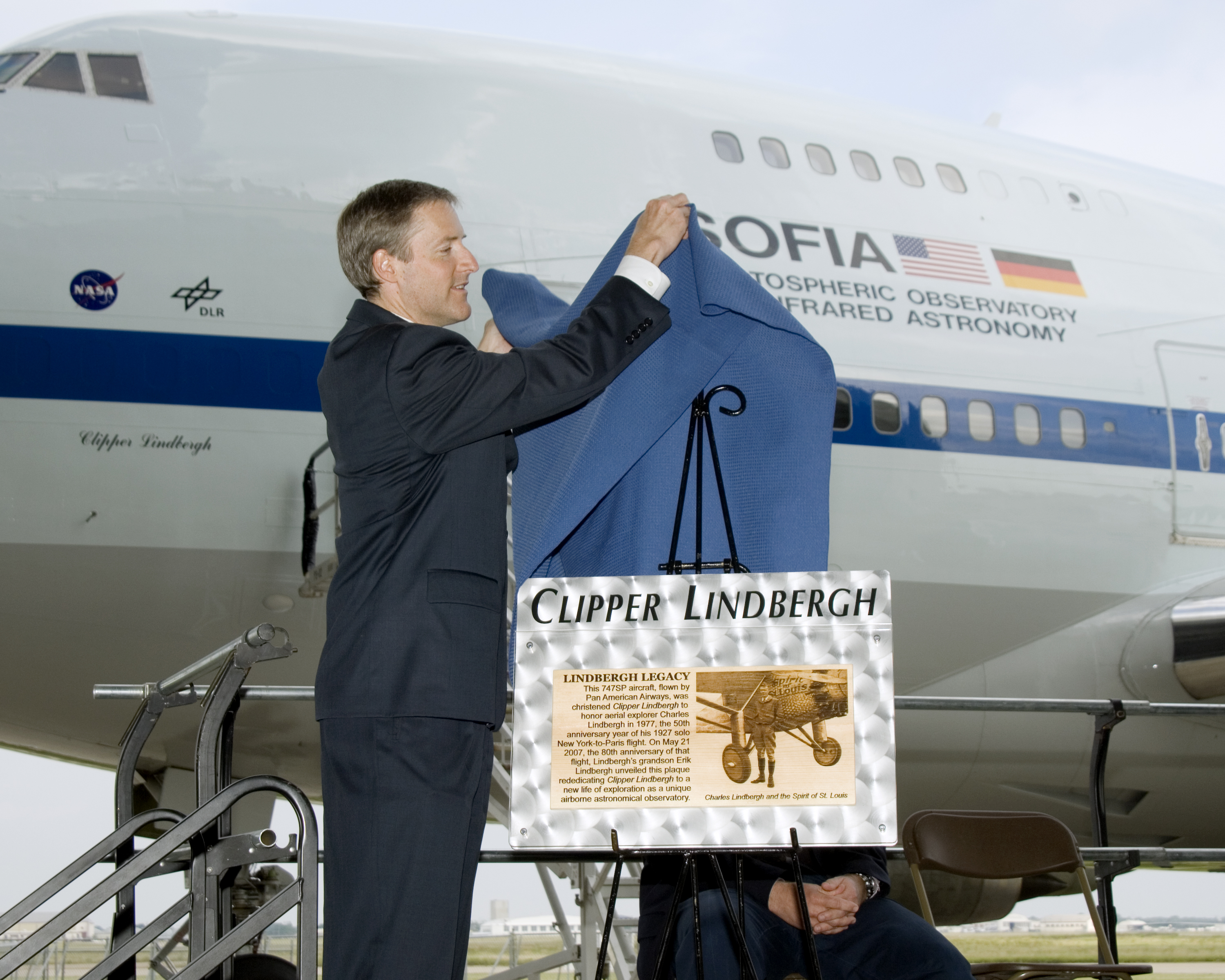 Erik Lindbergh unveils a plaque commemorating his grandfather to dedicate the 747 Clipper Lindbergh, a NASA airborne infrared observatory known as SOFIA