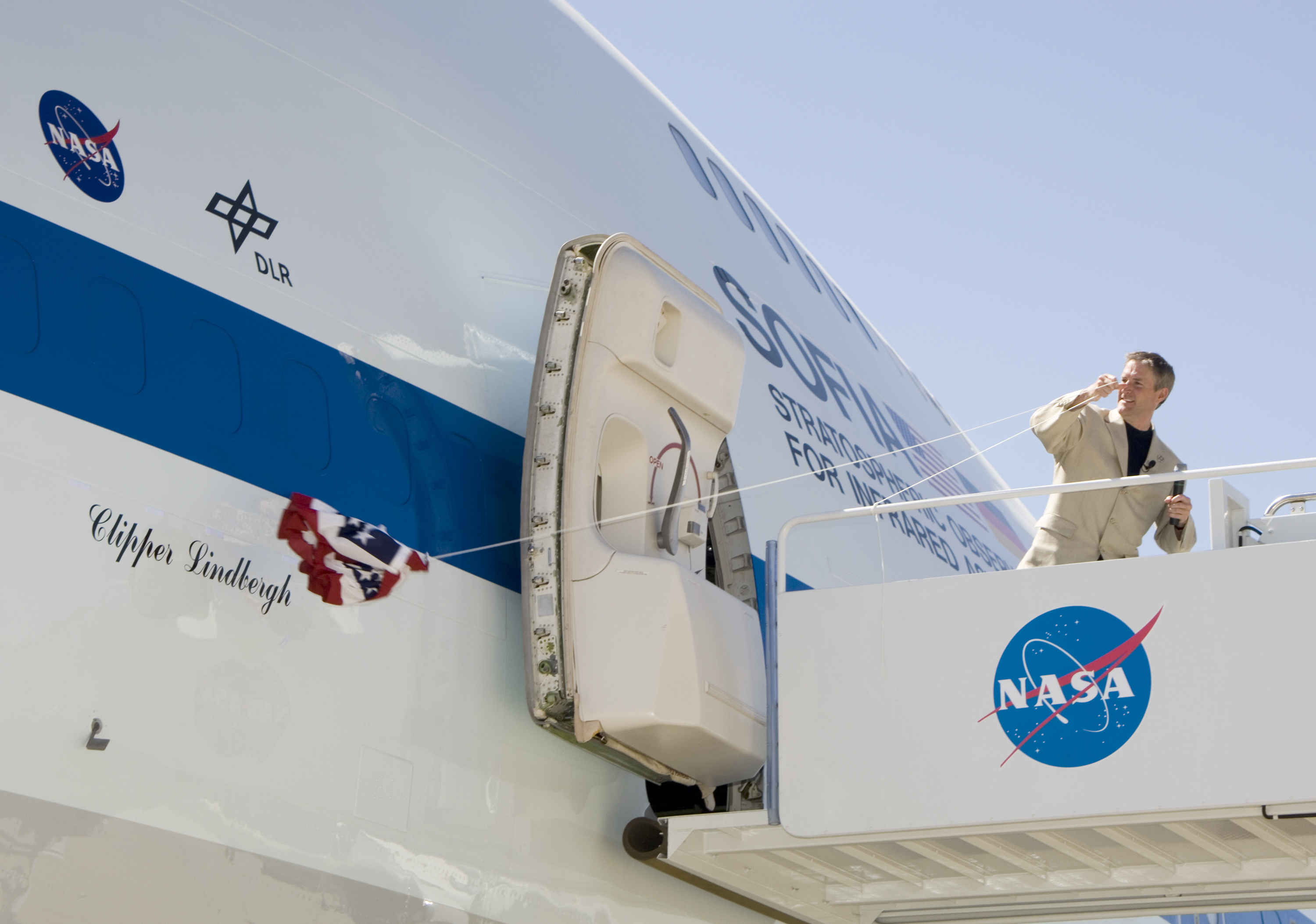 Erik Lindbergh, grandson of famed aviator Charles Lindbergh, yanks the bunting to reveal the Clipper Lindbergh name on NASA's SOFIA 747SP on June 27, 2007