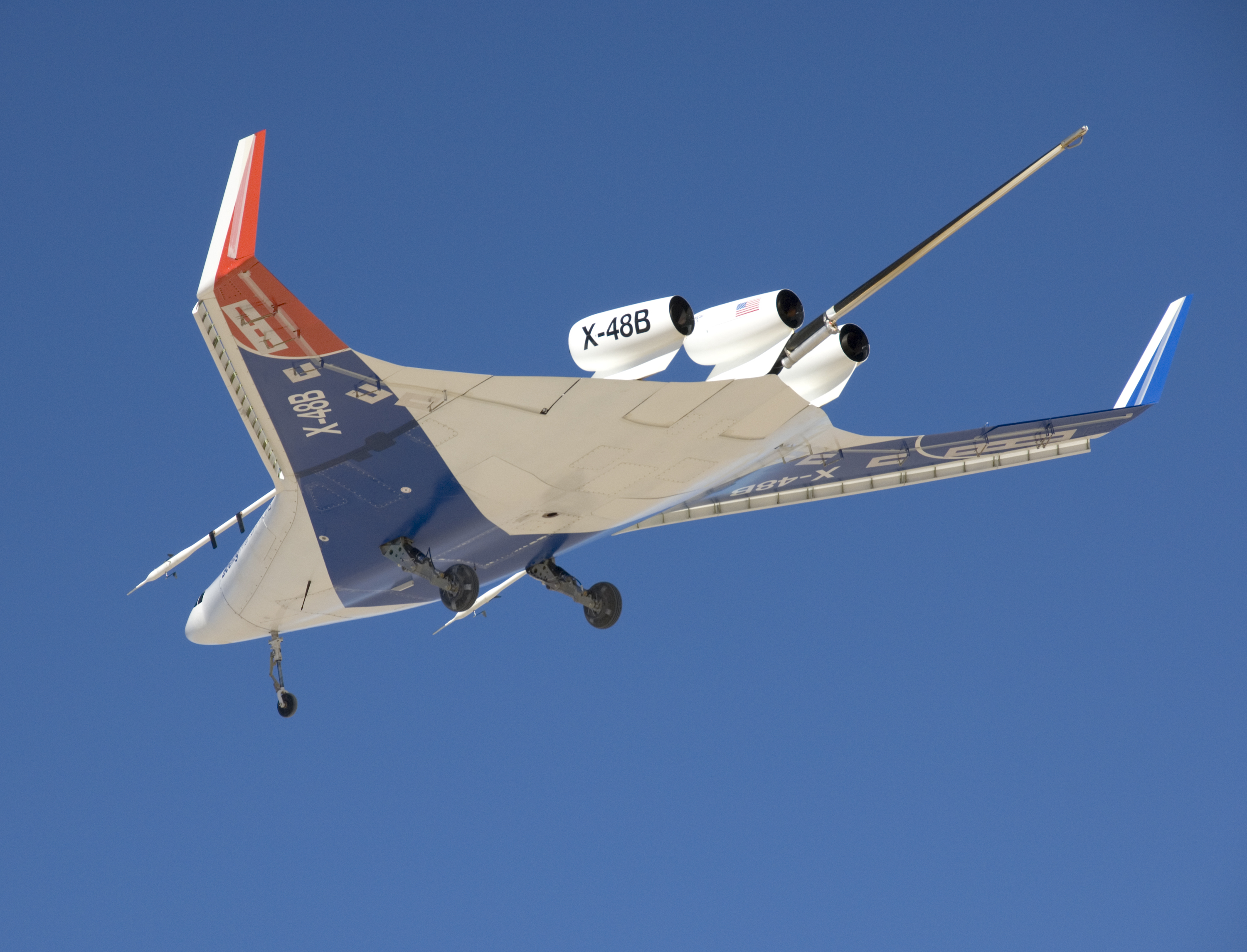 The unique manta-ray shaped planform of the Blended Wing Body X-48B is evidenced as the subscale demonstrator soars over Edwards AFB on its first test flight