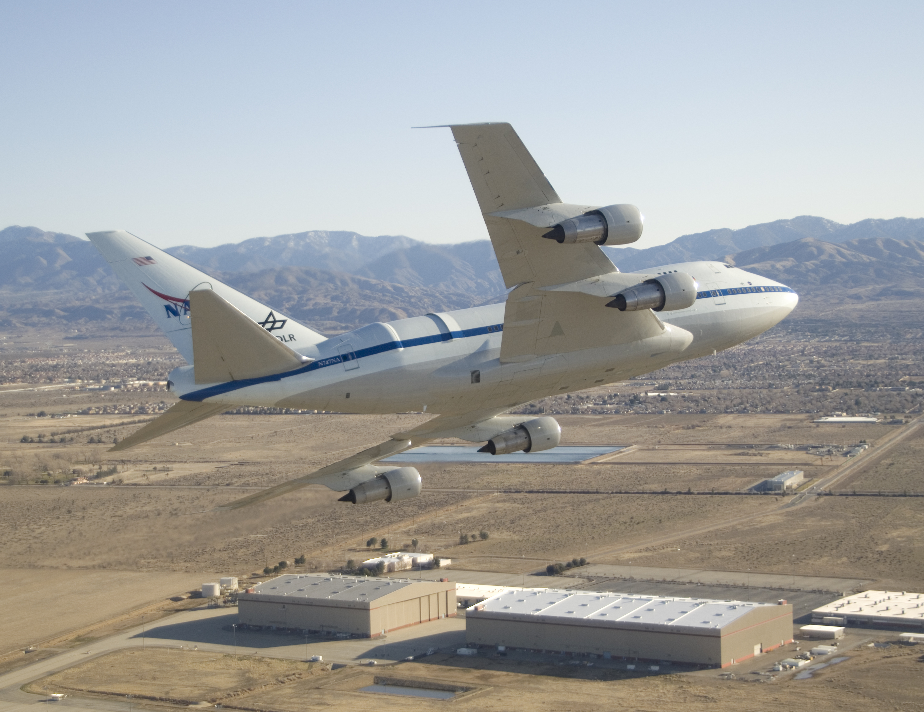 NASA's SOFIA flying infrared observatory banks over the Dryden Aircraft Operations Facility upon arrival at its new base of operations on Jan. 15, 2008.
