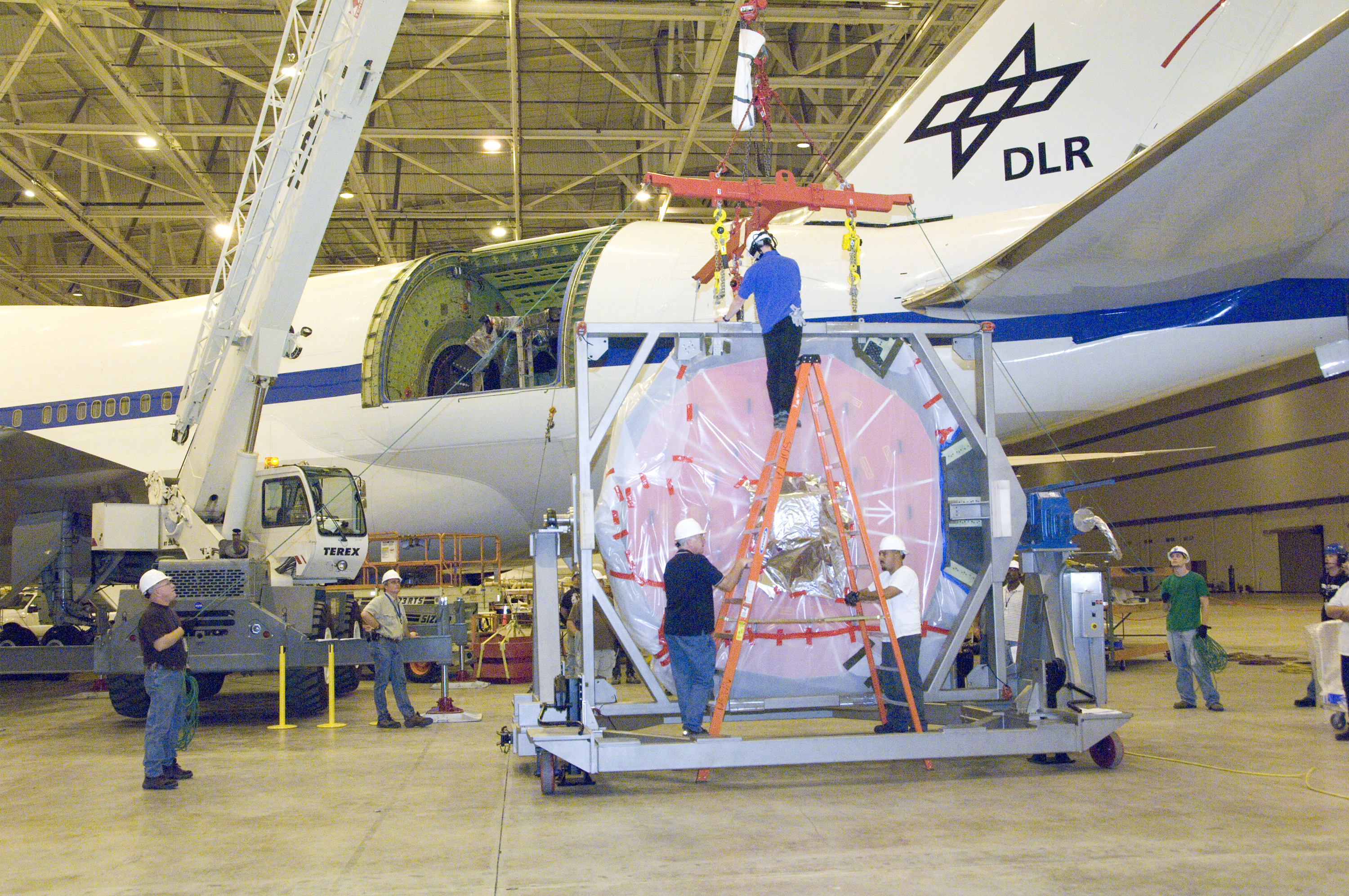 Engineers and technicians prepare SOFIA's German-built primary mirror assembly for reinstallation into NASA's 747SP airborne observatory