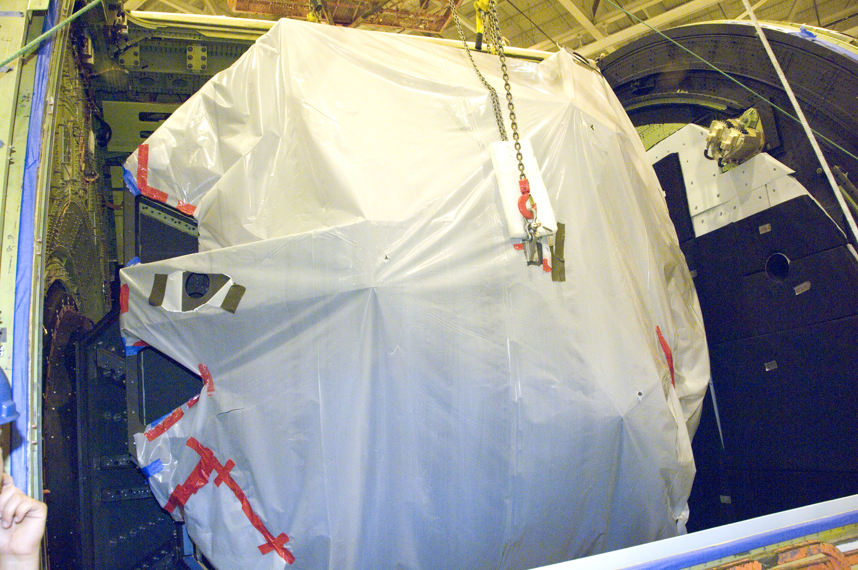 SOFIA's primary mirror is placed in the telescope cavity for reinstallation prior to telescope adjustments preparing SOFIA for first science