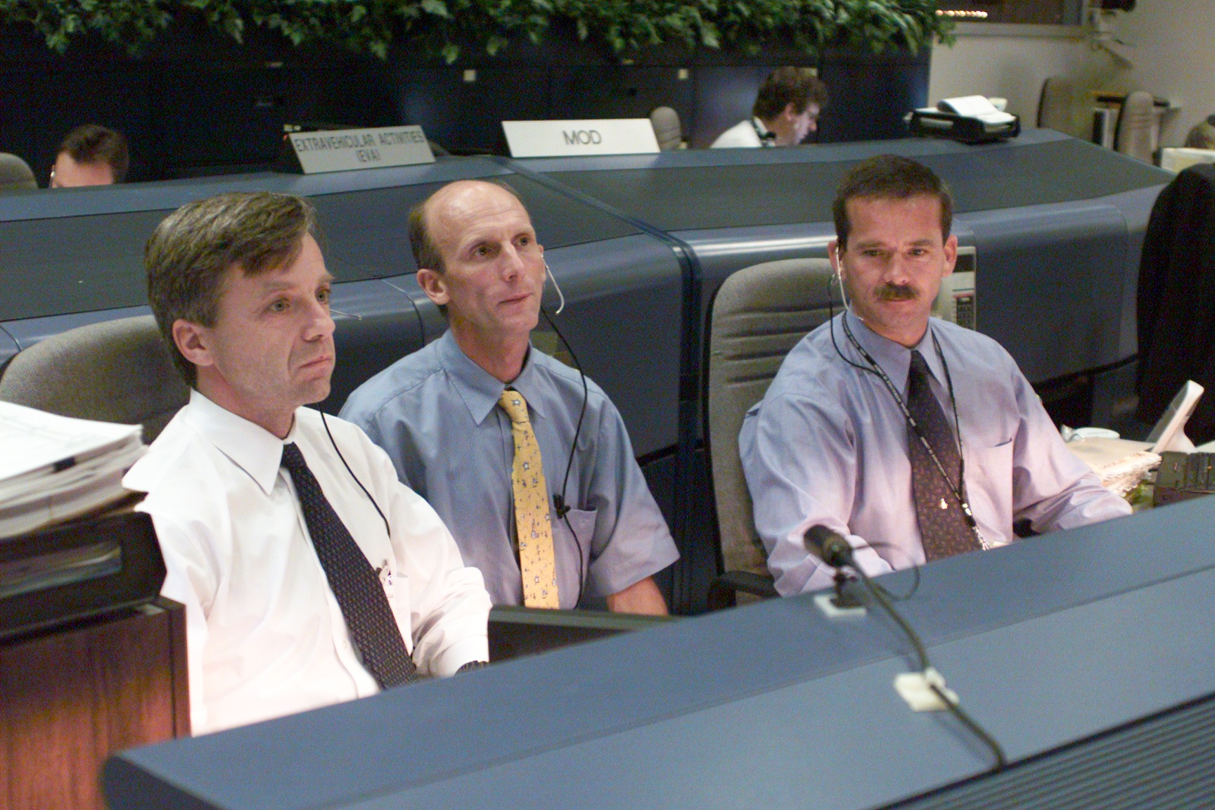 Various views of personnel in MCC during STS-106