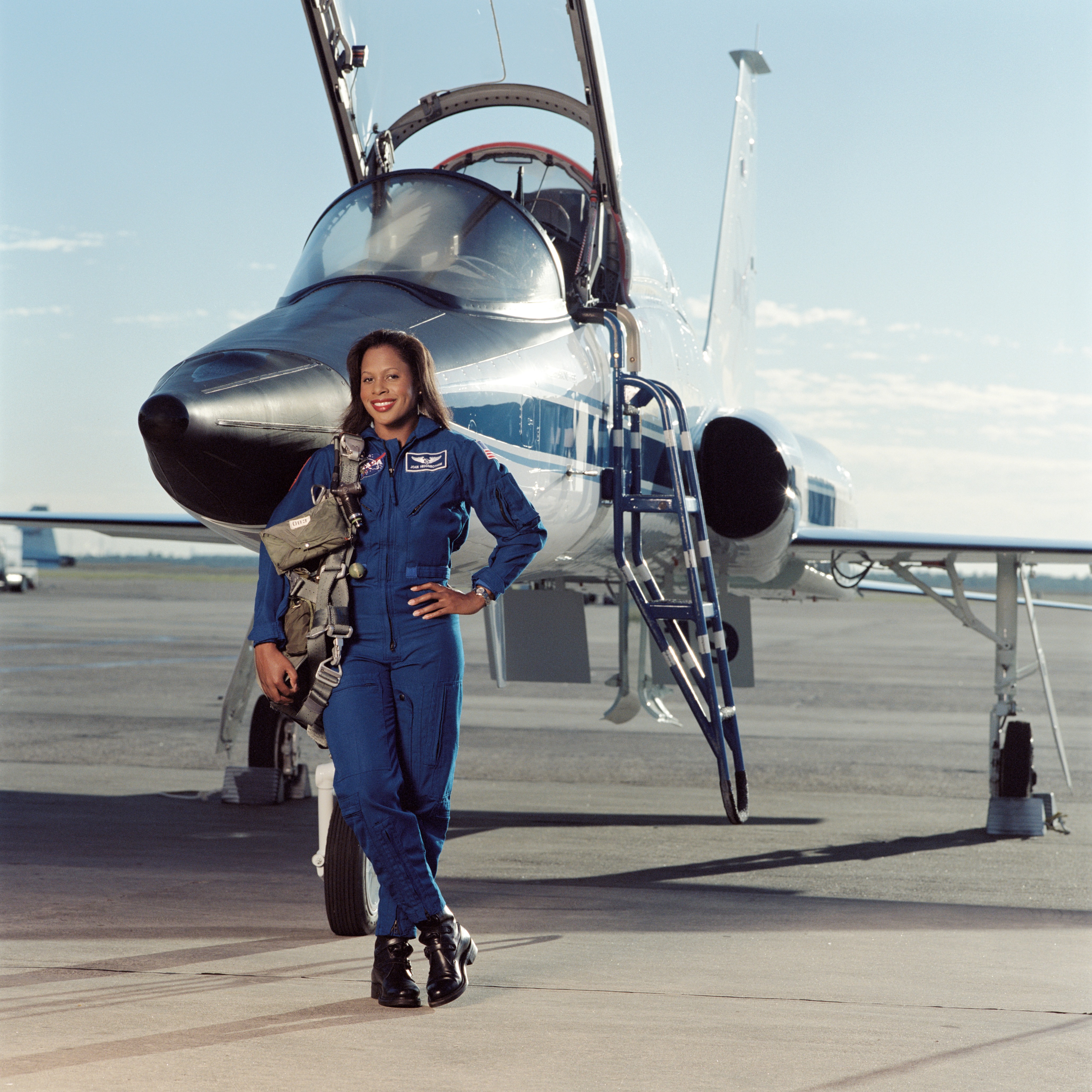 Joan Higginbotham posing in front of a T-38 aircraft and sitting in a T-38 cockpit