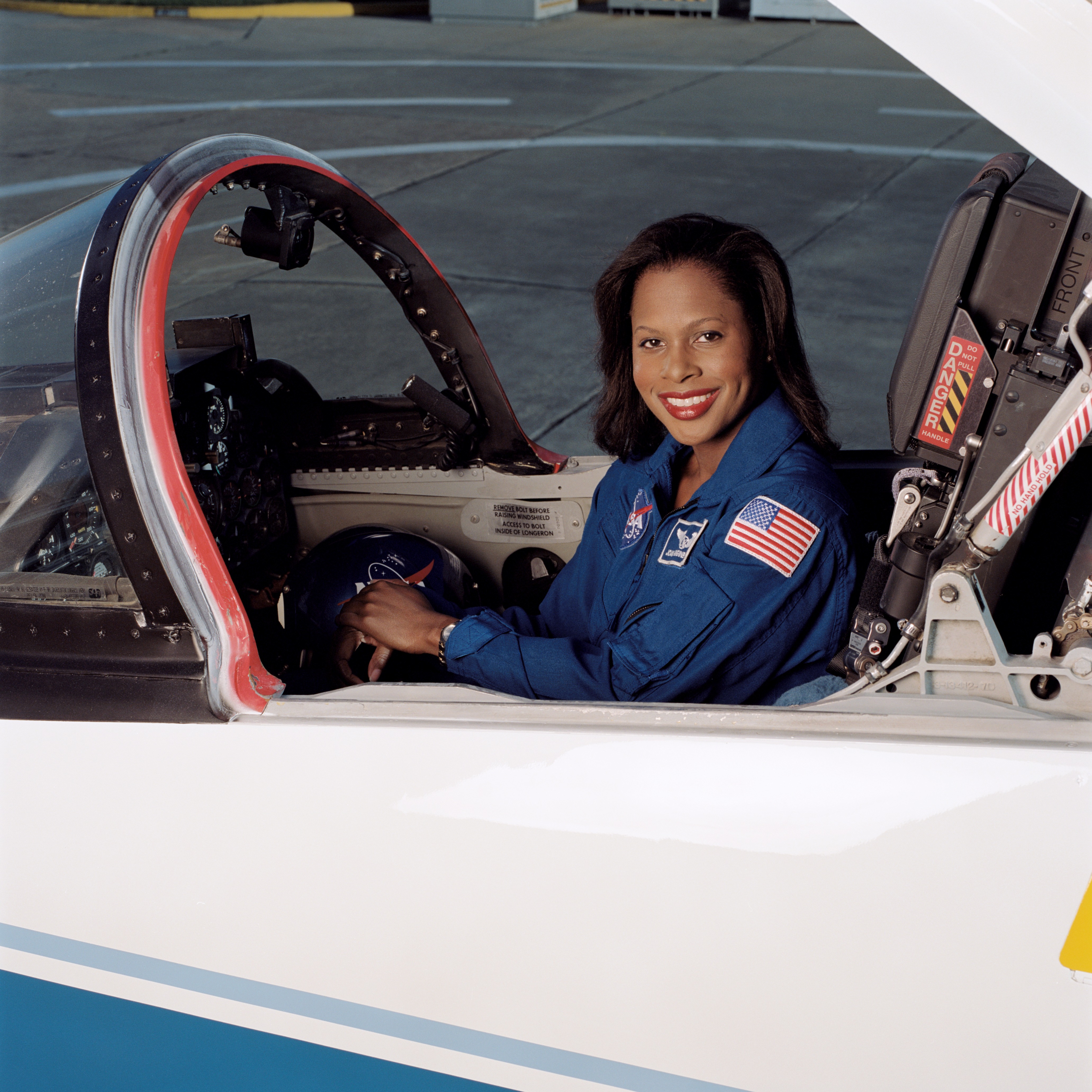 Joan Higginbotham posing in front of a T-38 aircraft and sitting in a T-38 cockpit