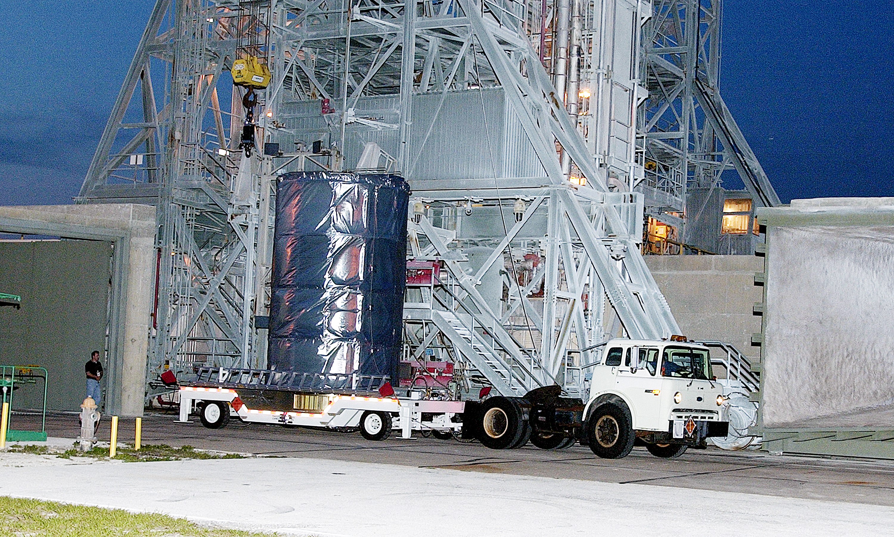 KENNEDY SPACE CENTER, FLA. - On Launch Complex 17-B, Cape Canaveral Air Force Station, the Space Infrared Telescope Facility (SIRTF) observatory is on a transporter to be taken back to NASA Spacecraft Hangar AE. SIRTF will remain in the clean room at Hangar AE until it returns to the pad in early August.