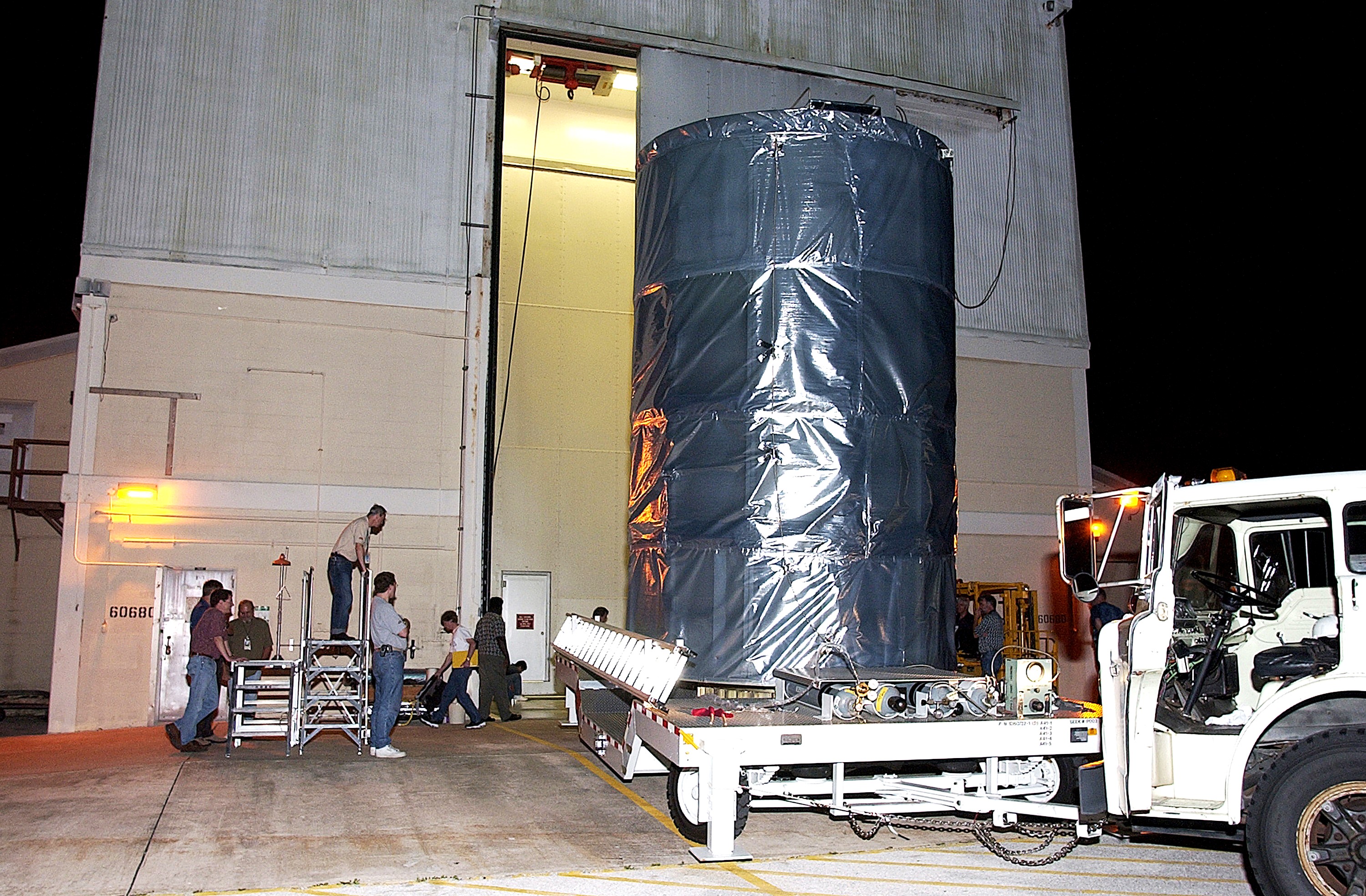 KENNEDY SPACE CENTER, FLA. - On Launch Complex 17-B, Cape Canaveral Air Force Station, the Space Infrared Telescope Facility (SIRTF) observatory is on a transporter to be taken back to NASA Spacecraft Hangar AE. SIRTF will remain in the clean room at Hangar AE until it returns to the pad in early August.