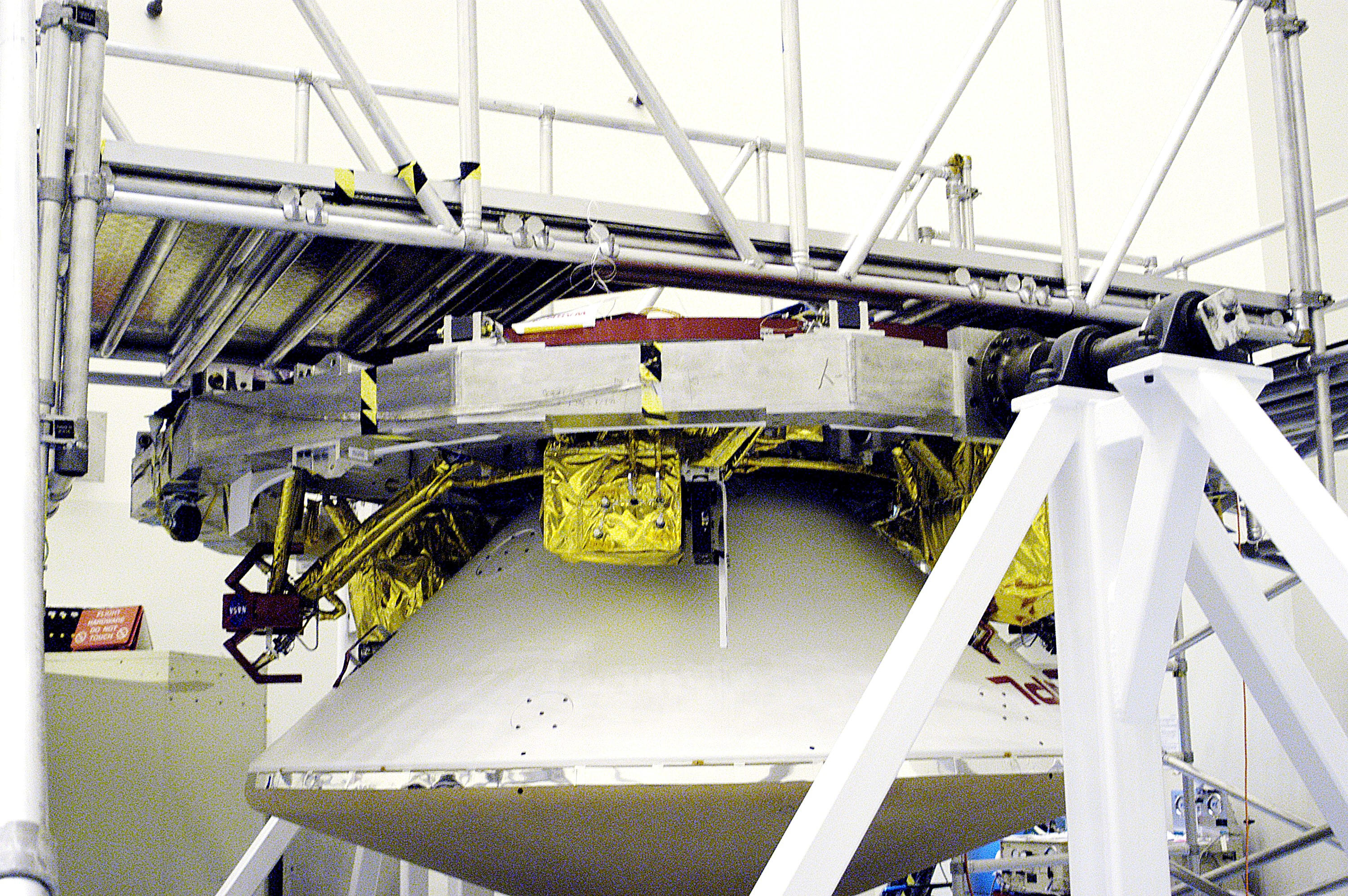 KENNEDY SPACE CENTER, FLA. - In the Payload Hazardous Servicing Facility, the cruise stage is mated to the Mars Exploration Rover 2 (MER-2) entry vehicle. The cruise stage includes fuel tanks, thruster clusters and avionics for steering and propulsion. NASA's twin Mars Exploration Rovers are designed to study the history of water on Mars. These robotic geologists are equipped with a robotic arm, a drilling tool, three spectrometers, and four pairs of cameras that allow them to have a human-like, 3D view of the terrain. Each rover could travel as far as 100 meters in one day to act as Mars scientists' eyes and hands, exploring an environment where humans can't yet go. MER-2 is scheduled to launch June 5 as MER-A aboard a Delta rocket from Cape Canaveral Air Force Station.