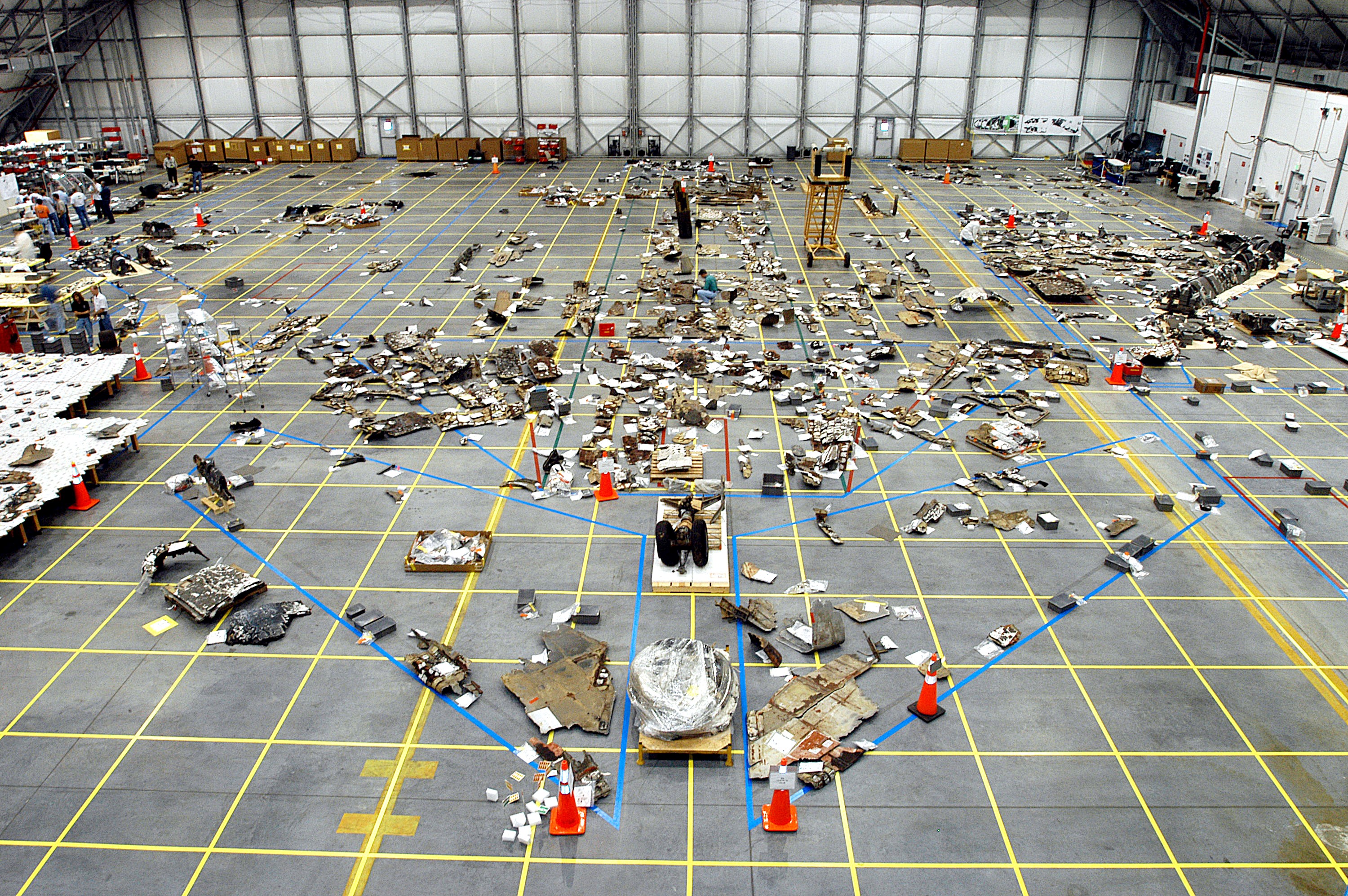 KENNEDY SPACE CENTER, FLA. - The floor of the RLV Hangar is full of pieces of Columbia debris delivered from the search and recovery efforts in East Texas. The items shipped to KSC number more than 82,000 and weigh 84,800 pounds or 38 percent of the total dry weight of Columbia. Of those items, 78,760 have been identified, with 753 placed on the left wing grid in the Hangar.