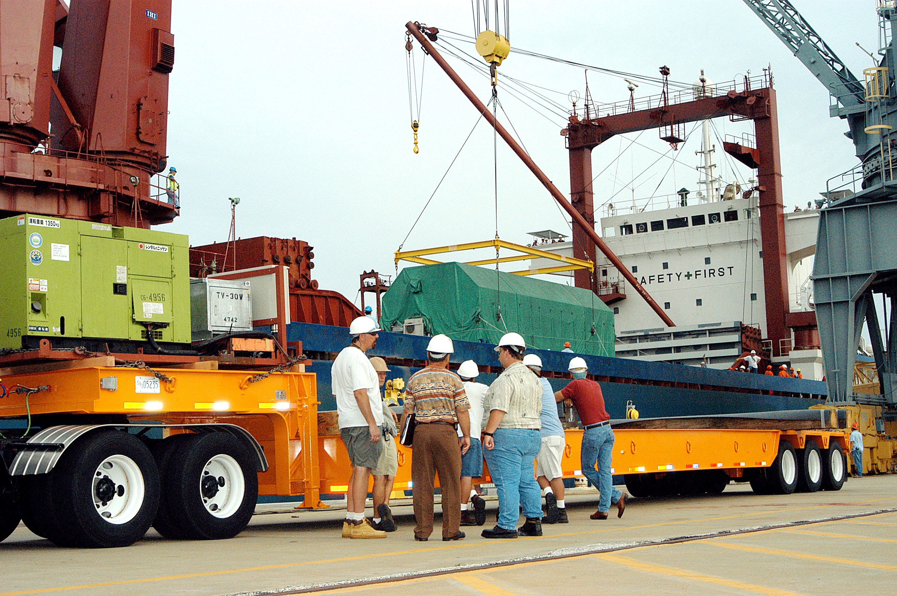 KENNEDY SPACE CENTER, FLA. - At Port Canaveral, the Pressurized Module of the Japanese Experiment Module (JEM) is lowered onto a truck bed. The container transport ship carrying JEM departed May 2 from Yokohama Harbor in Japan for the voyage to the United States. The National Space Development Agency of Japan (NASDA) developed the laboratory at the Tsukuba Space Center near Tokyo. The Pressurized Module is the first element of the JEM, named "Kibo" (Hope), to be delivered to KSC and will be transferred to the Space Station Processing Facility. The JEM is Japan's primary contribution to the Station. It will enhance the unique research capabilities of the orbiting complex by providing an additional environment for astronauts to conduct science experiments. The JEM also includes an exposed facility (platform) for space environment experiments, a robotic manipulator system, and two logistics modules. The various JEM components will be assembled in space over the course of three Shuttle missions.