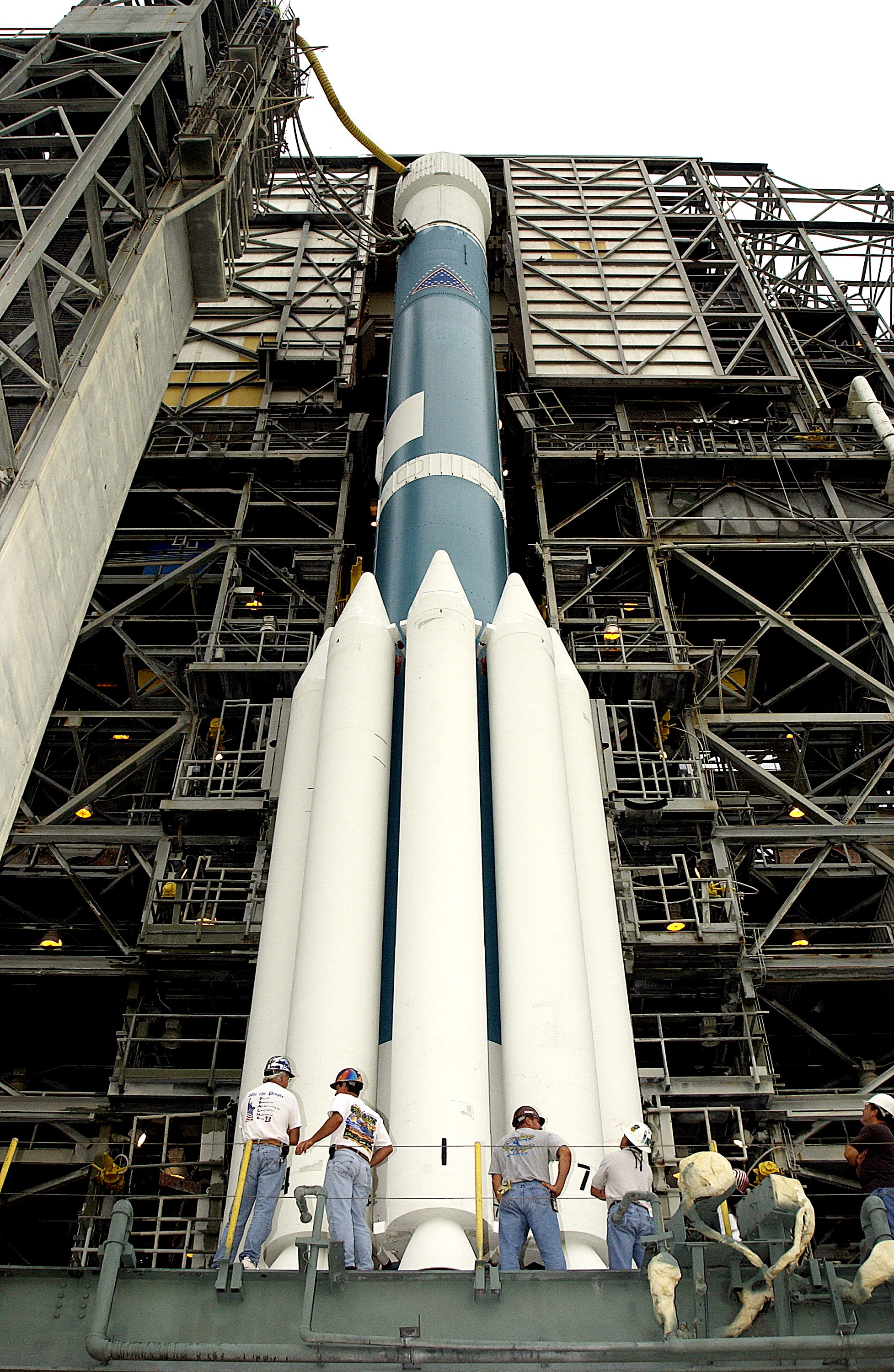 KENNEDY SPACE CENTER, FLA. - On Launch Complex 17-A, Cape Canaveral Air Force Station, the launch tower begins to roll back from the Boeing Delta II rocket and its Mars Exploration Rover (MER-A) payload in preparation for another launch attempt. The first two attempts were postponed due to weather concerns. MER-A is the first of two rovers being launched to Mars. When the two rovers arrive at Mars in 2004, they will bounce to airbag-cushioned landings at sites offering a balance of favorable conditions for safe landings and interesting science. The rovers see sharper images, can explore farther and examine rocks better than anything that has ever landed on Mars. The designated site for MER-A mission is Gusev Crater, which appears to have been a crater lake. The second rover, MER-B, is scheduled to launch June 25.