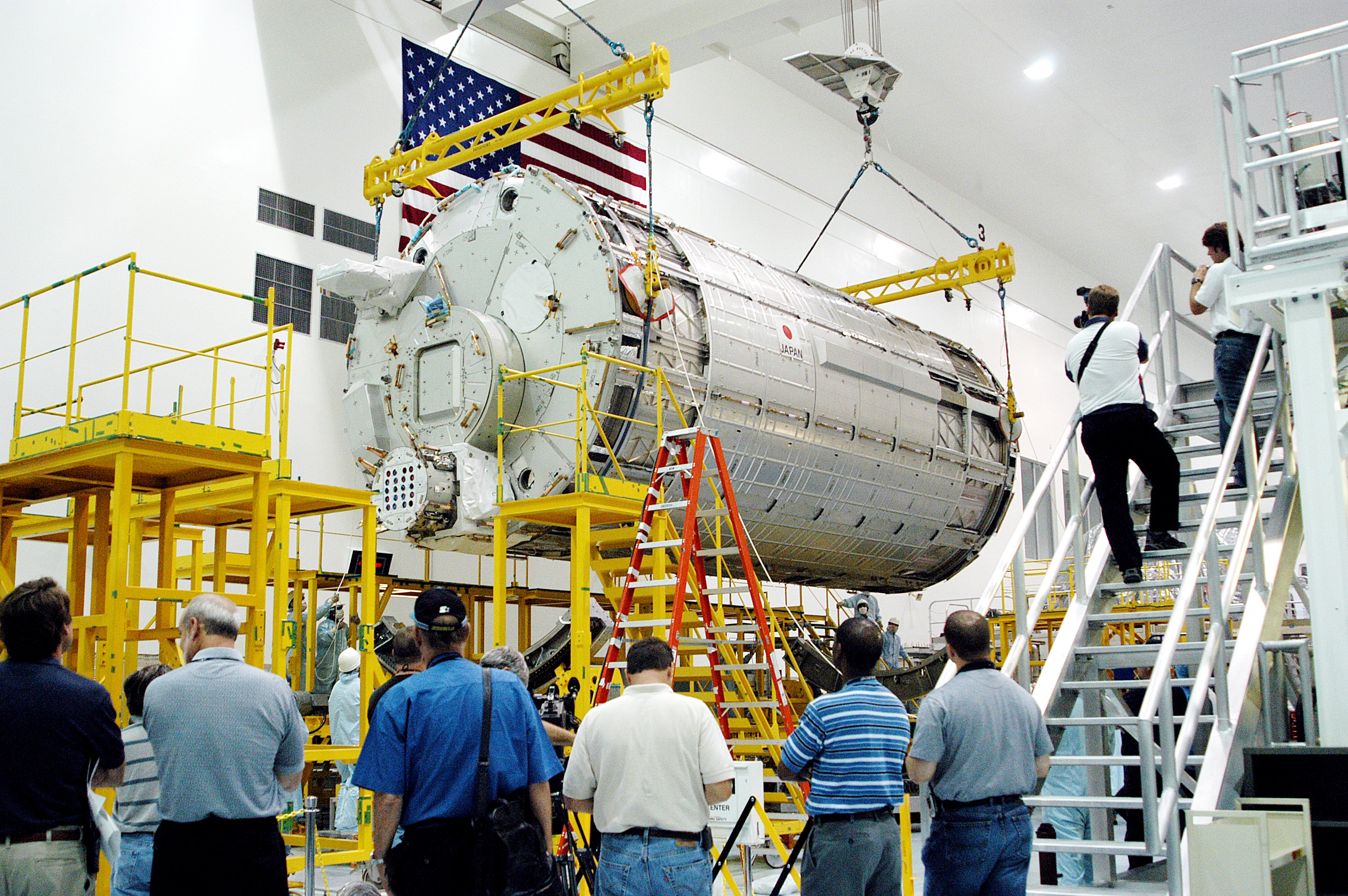 KENNEDY SPACE CENTER, FLA. - In the Space Station Processing Facility, the Japanese Experiment Module (JEM) pressure module is moved toward a work stand. A research laboratory, the pressurized module is the first element of the JEM, named "Kibo" (Hope), to be delivered to KSC. The National Space Development Agency of Japan (NASDA) developed the laboratory at the Tsukuba Space Center near Tokyo and is Japan's primary contribution to the Station. It will enhance the unique research capabilities of the orbiting complex by providing an additional environment for astronauts to conduct science experiments. The JEM also includes an exposed facility (platform) for space environment experiments, a robotic manipulator system, and two logistics modules. The various JEM components will be assembled in space over the course of three Shuttle missions.