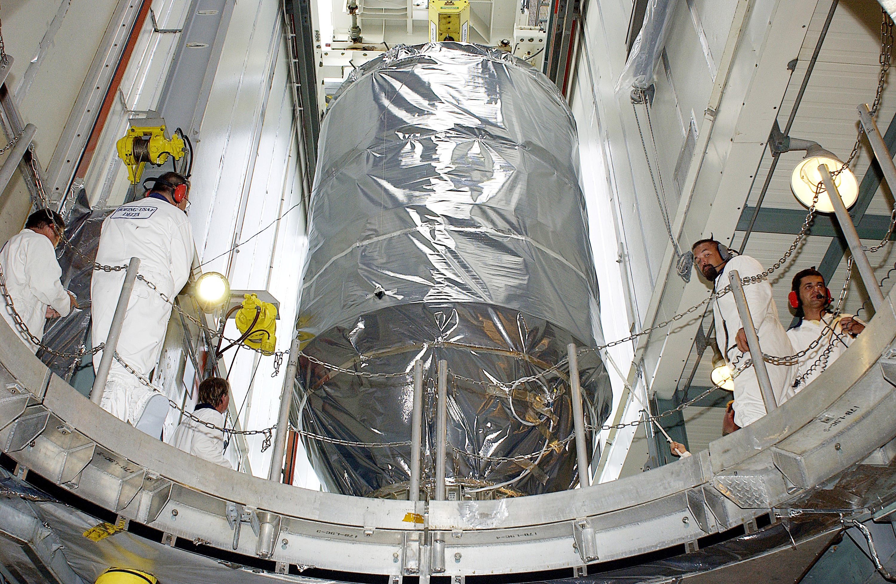 KENNEDY SPACE CENTER, FLA. - On Launch Pad 17-B, Cape Canaveral Air Force Station, the Mars Exploration Rover 1 (MER-B) is moved toward the opening above the Delta rocket. The rover will then be mated with the rocket for launch. The second of twin rovers being sent to Mars, it is equipped with a robotic arm, a drilling tool, three spectrometers, and four pairs of cameras that allow it to have a human-like, 3D view of the terrain. Each rover could travel as far as 100 meters in one day to act as Mars scientists' eyes and hands, exploring an environment where humans can't yet go. MER-B is scheduled to launch June 26 at one of two available times, 12:27:31 a.m. EDT or 1:08:45 a.m. EDT.