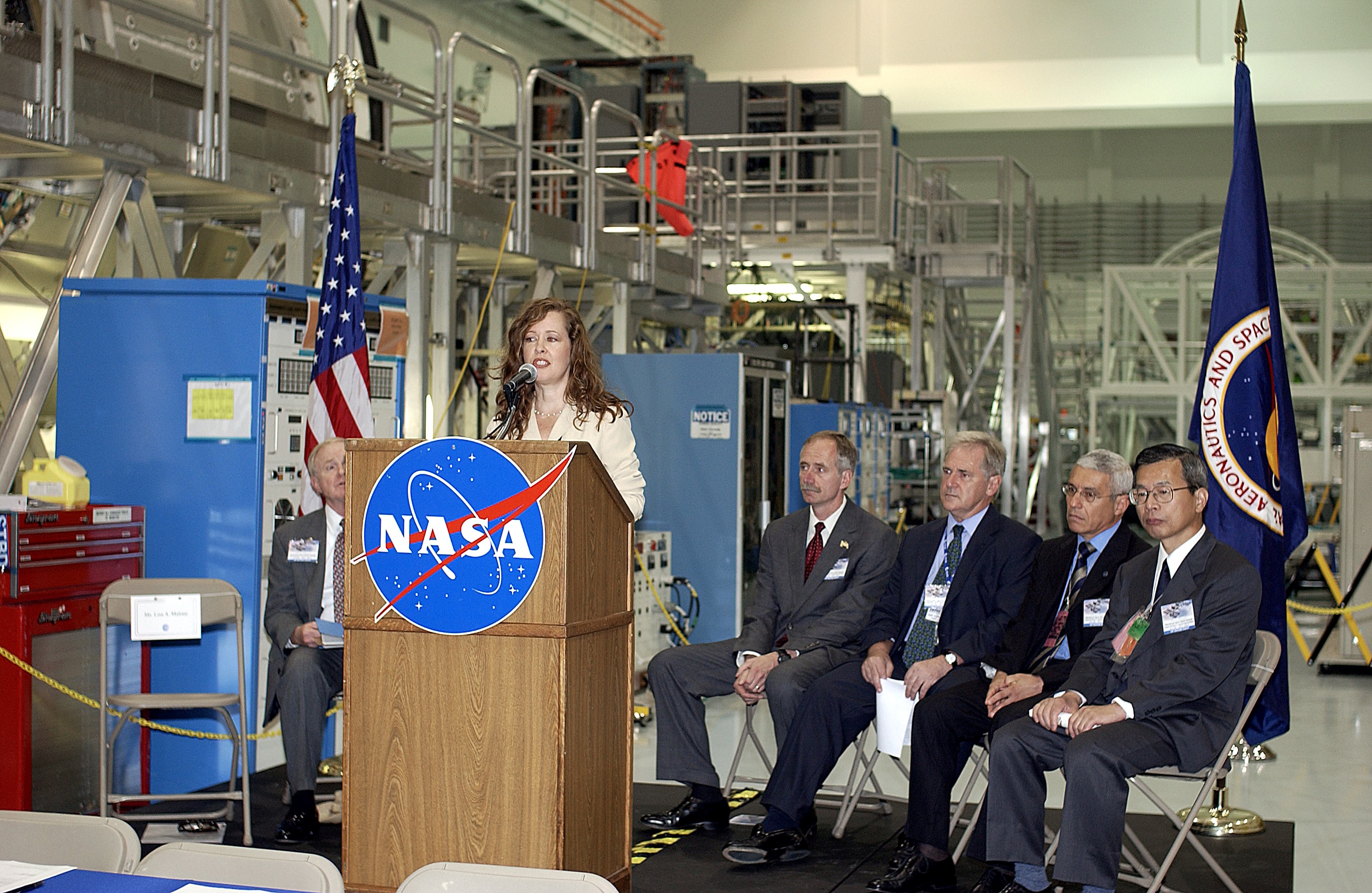 KENNEDY SPACE CENTER, FLA. - Lisa Malone, deputy director of External Relations and Business Development at KSC, emcees a ceremony in the Space Station Processing Facility to highlight the arrival of two major components of the International Space Station. NASA's Node 2, built by the European Space Agency (ESA) in Italy arrived at KSC on June 1. It will be the next pressurized module installed on the Station. The pressurized module of the Japanese Experiment Module (JEM), named "Kibo" (Hope) arrived at KSC on June 4. It is Japan's primary contribution to the Station. The ceremony held today included the official transfer of ownership signing of Node 2 between the ESA and NASA.. Speakers at the ceremony included KSC Director Roy Bridges Jr.; NASA's Michael C. Kostelnik, deputy associate administrator for International Space Station and Shuttle Programs, and William Gerstenmaier, International Space Station Program manager; Alan Thirkettle, International Space Station Program manager for Node 2, ESA; Andrea Lorenzoni, International Space Station Program manager for Node 2, Italian Space Agency; Kuniaki Shiraki, JEM Project manager, National Aerospace and Development Agency of Japan.