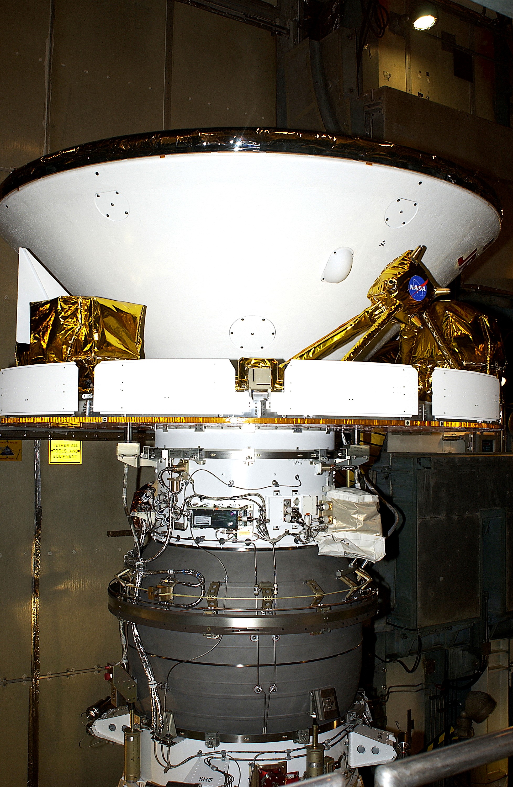 KENNEDY SPACE CENTER, FLA. - At Launch Complex 17-B, Cape Canaveral Air Force Station, Mars Exploration Rover-1 (MER-B) is prepared for the installation of its spacecraft fairing. The second of twin rovers being sent to Mars, it is equipped with a robotic arm, a drilling tool, three spectrometers, and four pairs of cameras that allow it to have a human-like, 3D view of the terrain. Each rover could travel as far as 100 meters in one day to act as Mars scientists' eyes and hands, exploring an environment where humans are not yet able to go. MER-B is scheduled to launch no earlier than June 28 at one of two available times, 11:56:16 p.m. EDT or 12:37:59 a.m. EDT.