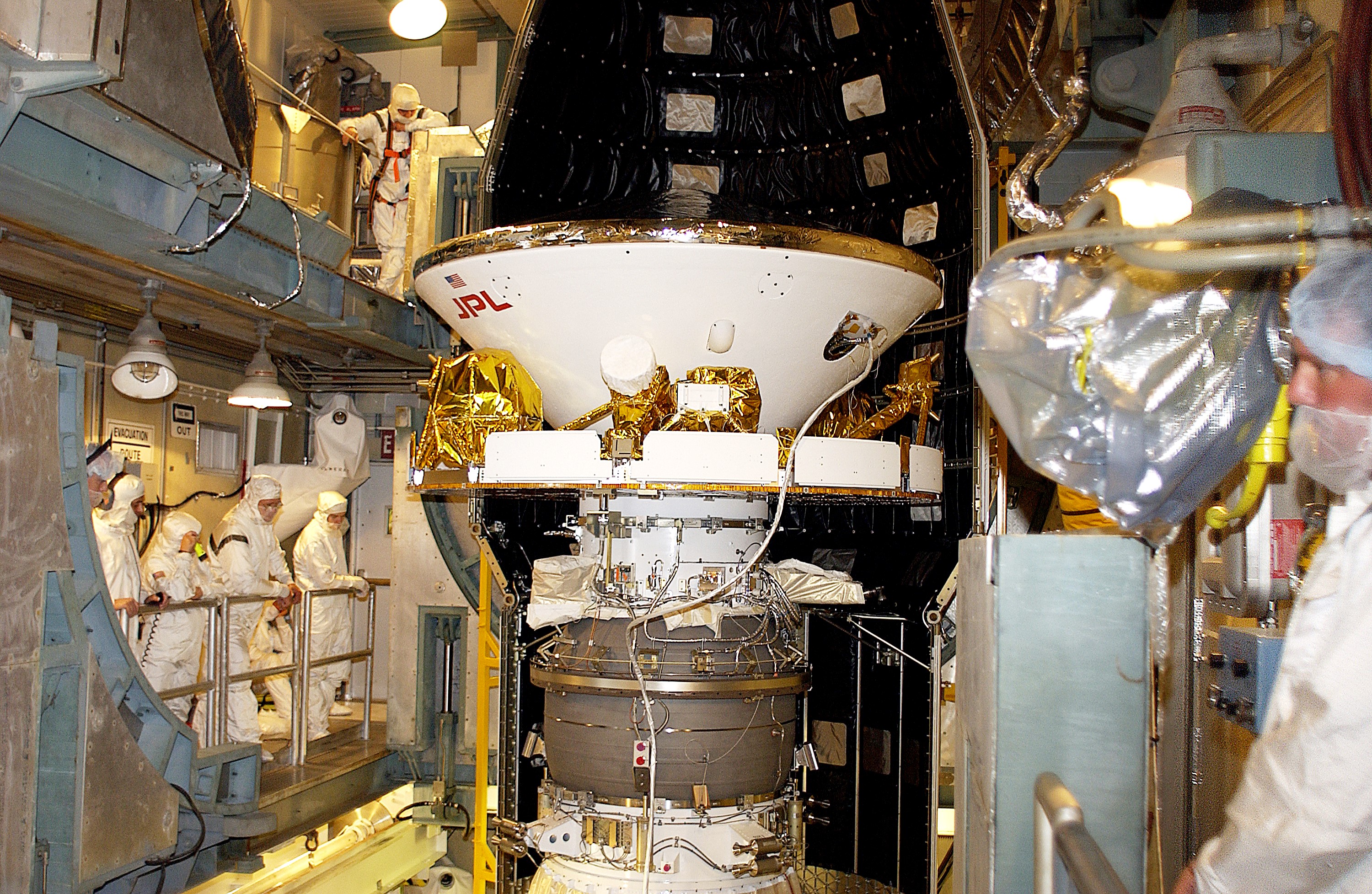 KENNEDY SPACE CENTER, FLA. - At Launch Complex 17-B, Cape Canaveral Air Force Station, workers prepare to encapsulate the Mars Exploration Rover-1 (MER-B) into its spacecraft fairing. The second of twin rovers being sent to Mars, it is equipped with a robotic arm, a drilling tool, three spectrometers, and four pairs of cameras that allow it to have a human-like, 3D view of the terrain. Each rover could travel as far as 100 meters in one day to act as Mars scientists' eyes and hands, exploring an environment where humans are not yet able to go. MER-B is scheduled to launch no earlier than June 28 at one of two available times, 11:56:16 p.m. EDT or 12:37:59 a.m. EDT.
