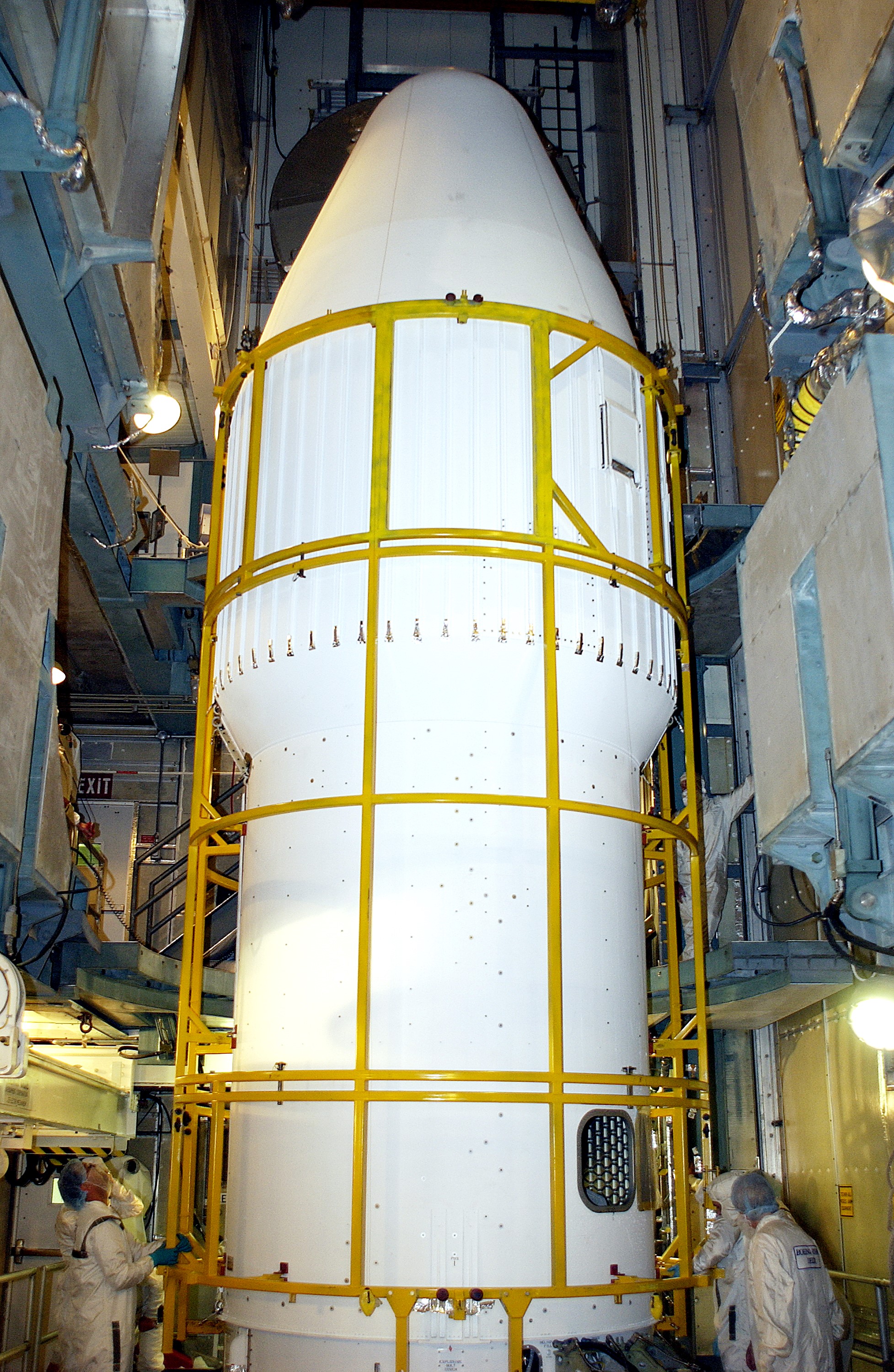 KENNEDY SPACE CENTER, FLA. - At Launch Complex 17-B, Cape Canaveral Air Force Station, workers complete the installation of the spacecraft fairing around the Mars Exploration Rover-1 (MER-B) for launch. The second of twin rovers being sent to Mars, it is equipped with a robotic arm, a drilling tool, three spectrometers, and four pairs of cameras that allow it to have a human-like, 3D view of the terrain. Each rover could travel as far as 100 meters in one day to act as Mars scientists' eyes and hands, exploring an environment where humans are not yet able to go. MER-B is scheduled to launch no earlier than June 28 at one of two available times, 11:56:16 p.m. EDT or 12:37:59 a.m. EDT.