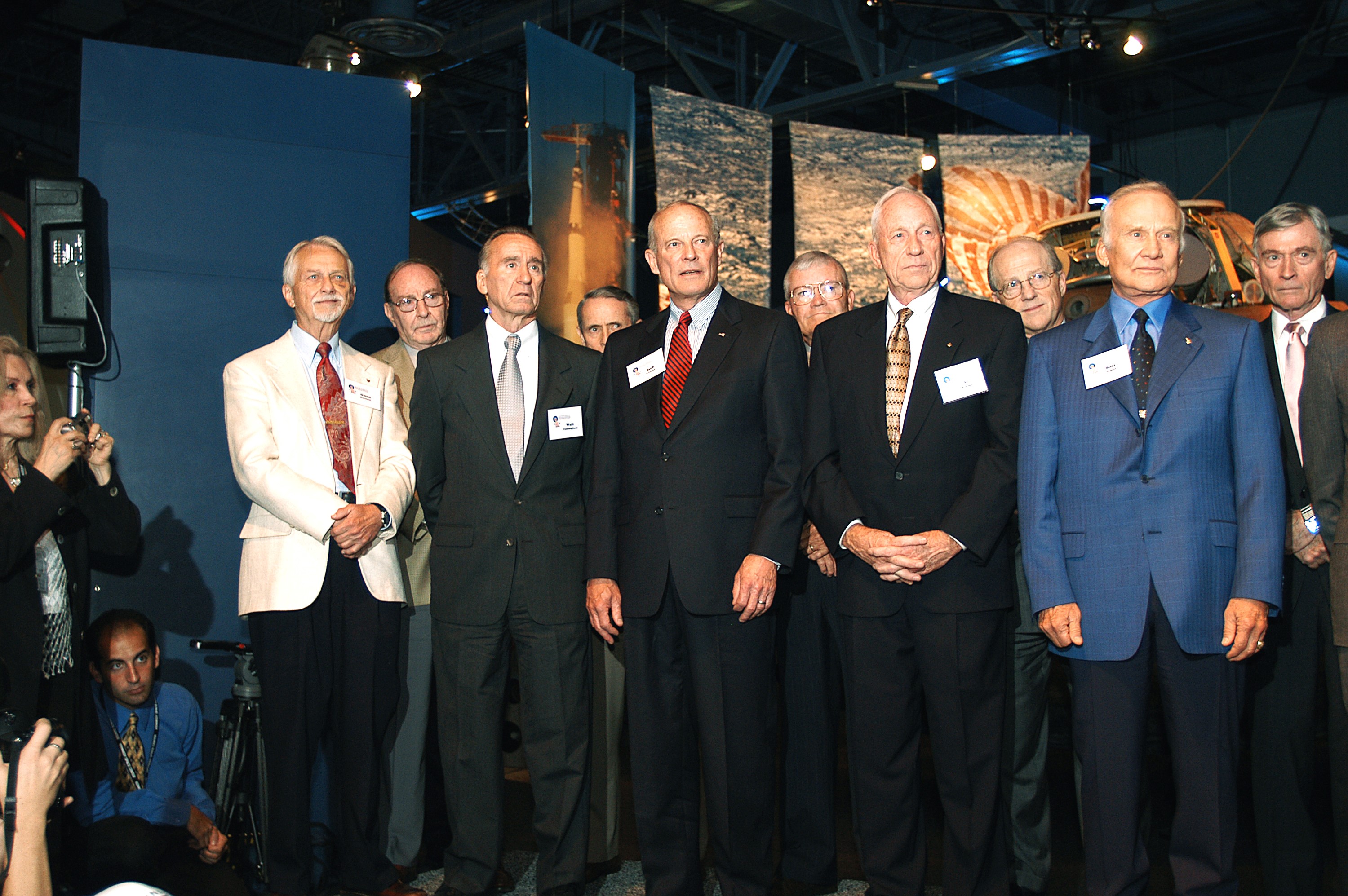 KENNEDY SPACE CENTER, FLA. - A group of current and former U.S. astronauts are introduced to the audience at a ribbon cutting ceremony officially opening the U.S. Astronaut Hall of Fame as part of the Kennedy Space Center Visitor Complex. In the front row, from left, are Owen K. Garriott, Walter Cunningham, Jack R. Lousma, Alfred M. Worden, and Buzz Aldrin. In the back row, from left, are Edgar D. Mitchell, Edward G. Gibson, Fred W. Haise, Frederick H. (Rick) Hauck, and John W. Young. The ceremony was held in conjunction with the induction of four Space Shuttle astronauts into the Hall of Fame including Daniel Brandenstein, Robert "Hoot" Gibson, Story Musgrave, and Sally Ride. Conceived by six of the Mercury Program astronauts, the U.S. Astronaut Hall of Fame opened in 1990 to provide a place where space travelers could be remembered for their participation and accomplishments in the U.S. space program. The four new inductees join 48 previously honored astronauts from the ranks of the Gemini, Apollo, Skylab, Apollo-Soyuz, and Space Shuttle programs.
