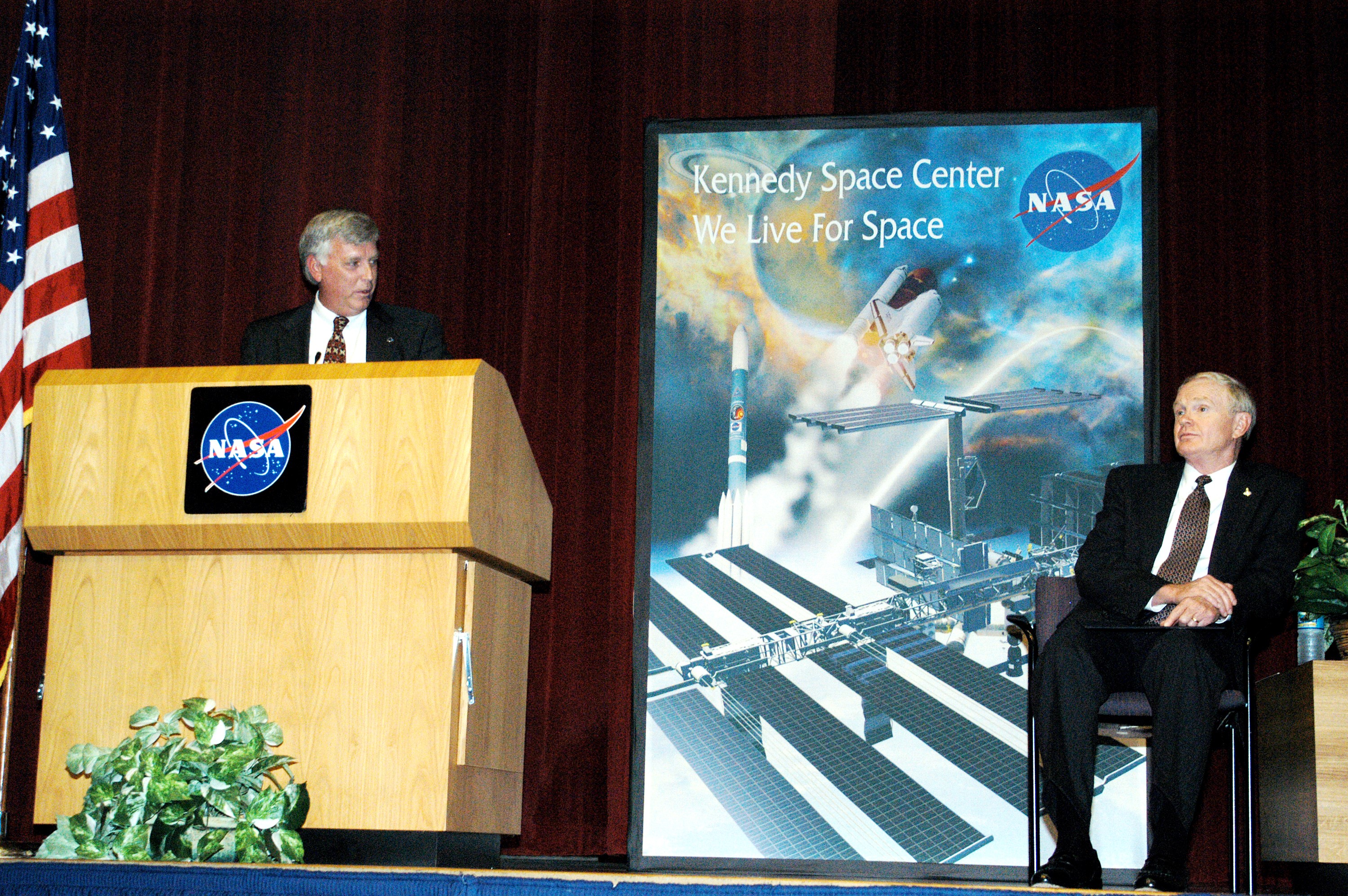 KENNEDY SPACE CENTER, FLA. - KSC Deputy Director James W. Kennedy addresses a group of KSC employees assembled in the KSC Training Auditorium, as KSC Director Roy D. Bridges looks on (right). The occasion is the announcement of Kennedy as the next director of the NASA Kennedy Space Center (KSC) in Florida. Kennedy has served as KSC's deputy director since November 2002. He will succeed Bridges, who was appointed on June 13 to lead NASA's Langley Research Center, Hampton, Va.