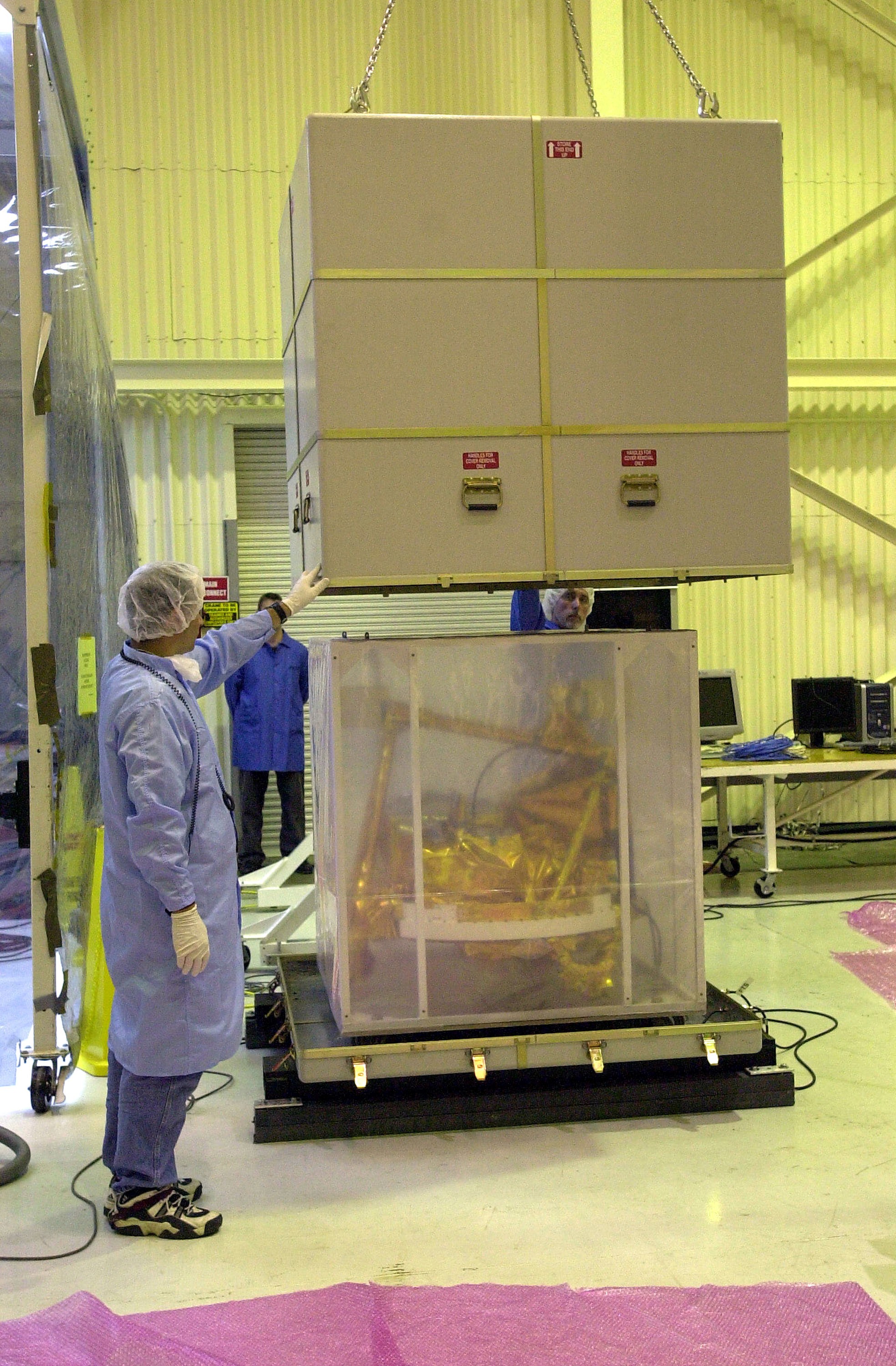 KENNEDY SPACE CENTER, FLA. - The SciSat-1 spacecraft is uncrated at Vandenberg Air Force Base, Calif. SciSat-1 weighs approximately 330 pounds and will be placed in a 400-mile-high polar orbit to investigate processes that control the distribution of ozone in the upper atmosphere. The scientific mission of SciSat-1 is to measure and understand the chemical processes that control the distribution of ozone in the Earth’s atmosphere, particularly at high altitudes. The data from the satellite will provide Canadian and international scientists with improved measurements relating to global ozone processes and help policymakers assess existing environmental policy and develop protective measures for improving the health of our atmosphere, preventing further ozone depletion. The mission is designed to last two years.
