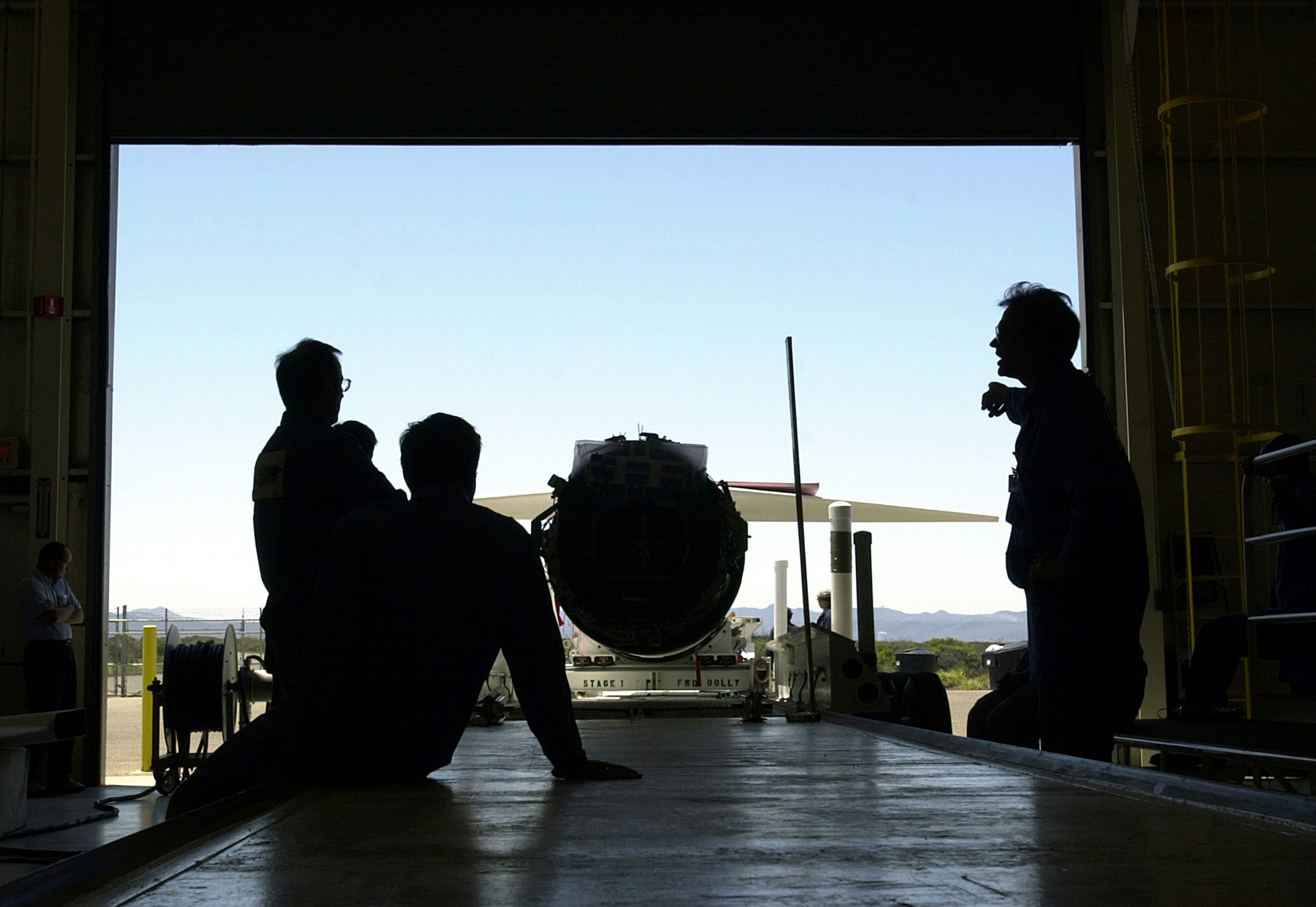 KENNEDY SPACE CENTER, FLA. - Inside the hangar at Vandenberg Air Force Base, Calif., workers wait for the Pegasus launch vehicle to be moved inside. The Pegasus will carry the SciSat-1 spacecraft in a 400-mile-high polar orbit to investigate processes that control the distribution of ozone in the upper atmosphere. The scientific mission of SciSat-1 is to measure and understand the chemical processes that control the distribution of ozone in the Earth’s atmosphere, particularly at high altitudes. The data from the satellite will provide Canadian and international scientists with improved measurements relating to global ozone processes and help policymakers assess existing environmental policy and develop protective measures for improving the health of our atmosphere, preventing further ozone depletion. The mission is designed to last two years.