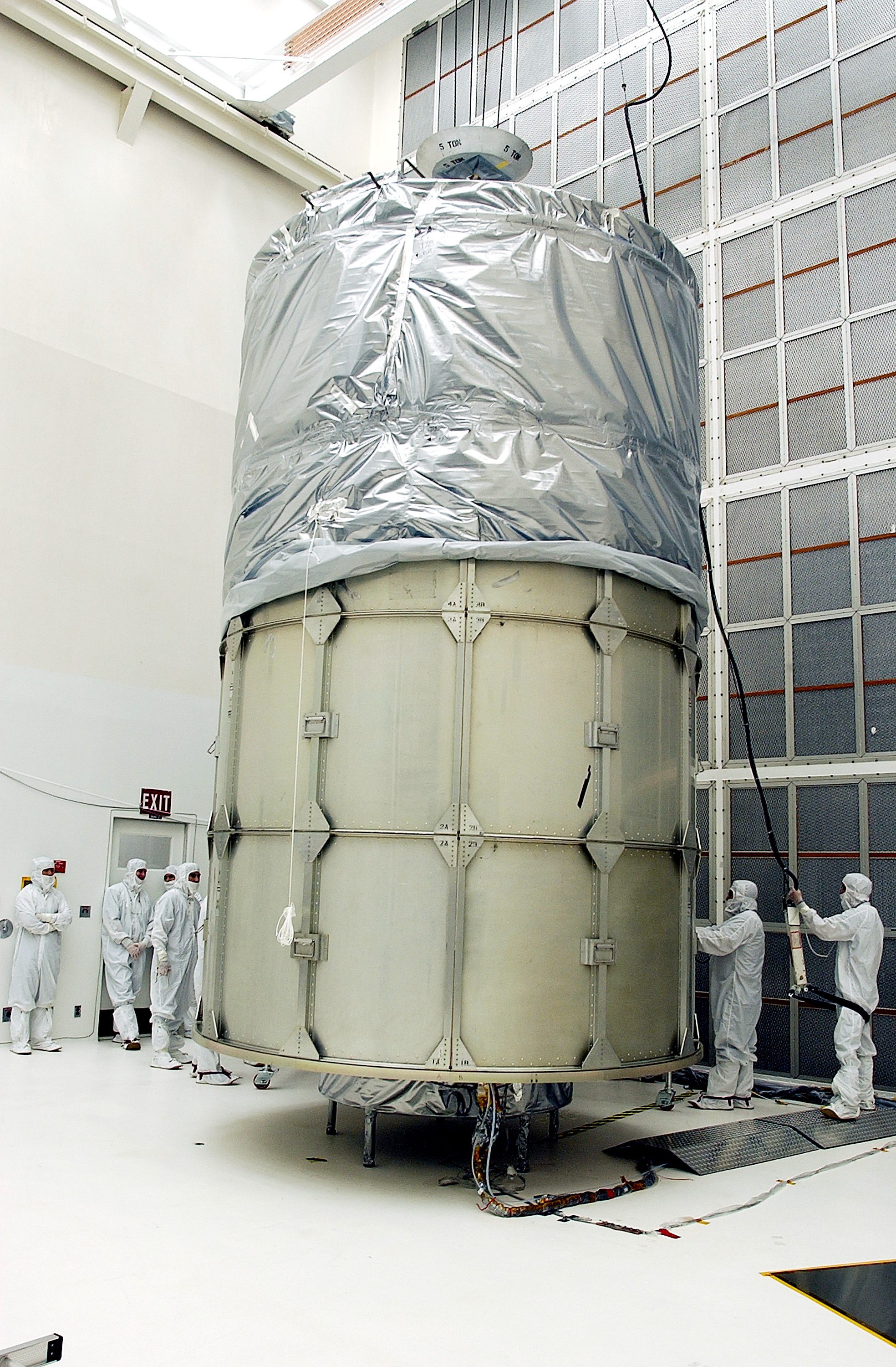 KENNEDY SPACE CENTER, FLA. - In Hangar A&E, Cape Canaveral Air Force Station, encapsulation of the Space Infrared Telescope Facility (SIRTF) is complete. The spacecraft will be transported to Launch Complex 17-B for mating with its launch vehicle, the Delta II rocket. SIRTF consists of three cryogenically cooled science instruments and an 0.85-meter telescope, and is one of NASA's largest infrared telescopes to be launched. SIRTF will obtain images and spectra by detecting the infrared energy, or heat, radiated by objects in space. Most of this infrared radiation is blocked by the Earth's atmosphere and cannot be observed from the ground.