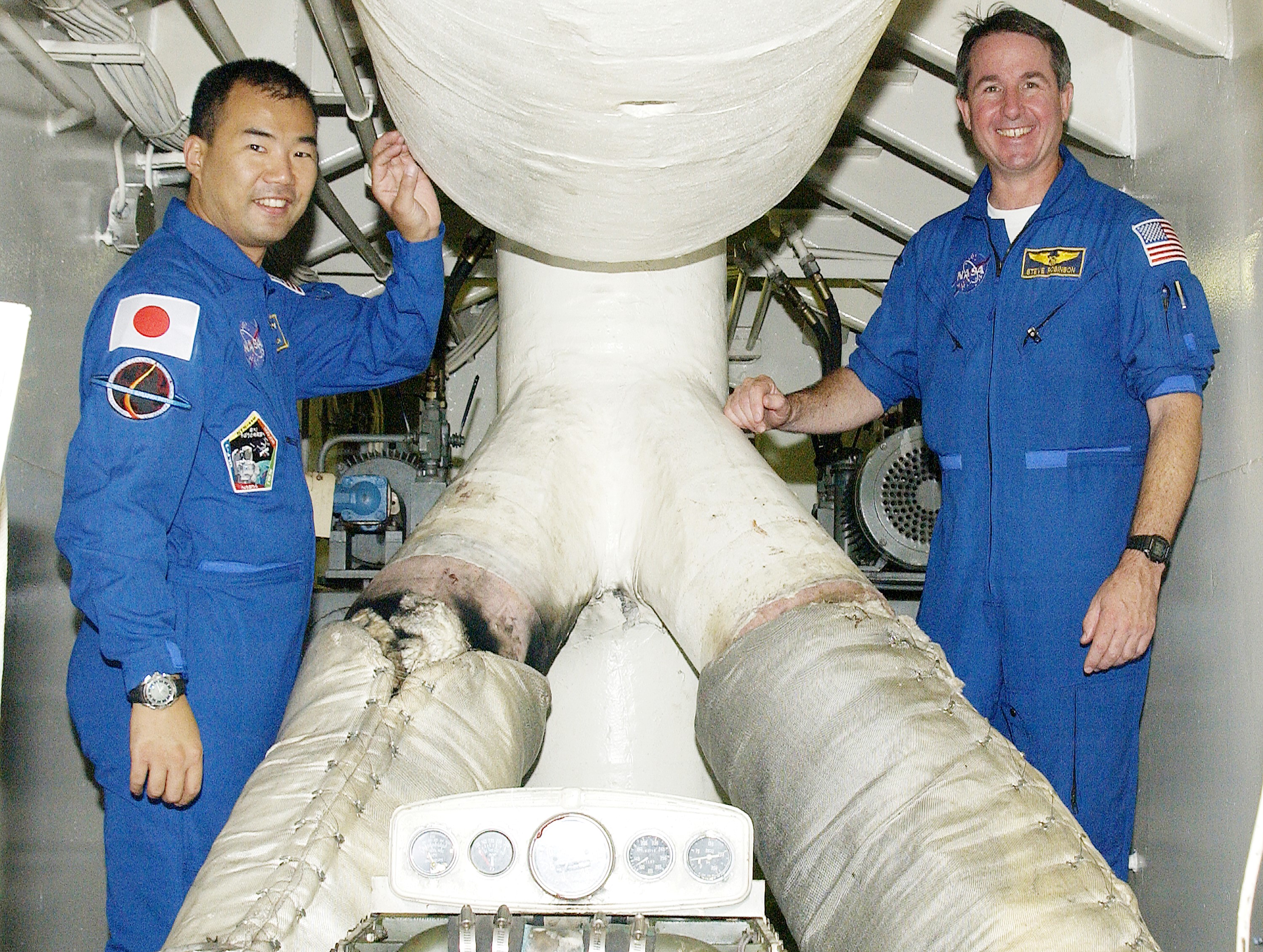 KENNEDY SPACE CENTER, FLA. - STS-114 Mission Specialists Soichi Noguchi and Stephen Robinson visit the engine room of the Liberty Star, one of two SRB Retrieval Ships. Noguchi is with the Japanese space agency NASDA. Other crew members on the tour are Commander Eileen Collins and Pilot James Kelly. On their mission, the crew will carry the MultiPurpose Logistics Module (MPLM) Raffaello and External Stowage Platform 2 to the International Space Station. The MPLM will contain supplies and equipment. Another goal of the mission is to remove and replace a Control Moment Gyro. Launch date for mission STS-114 is under review.
