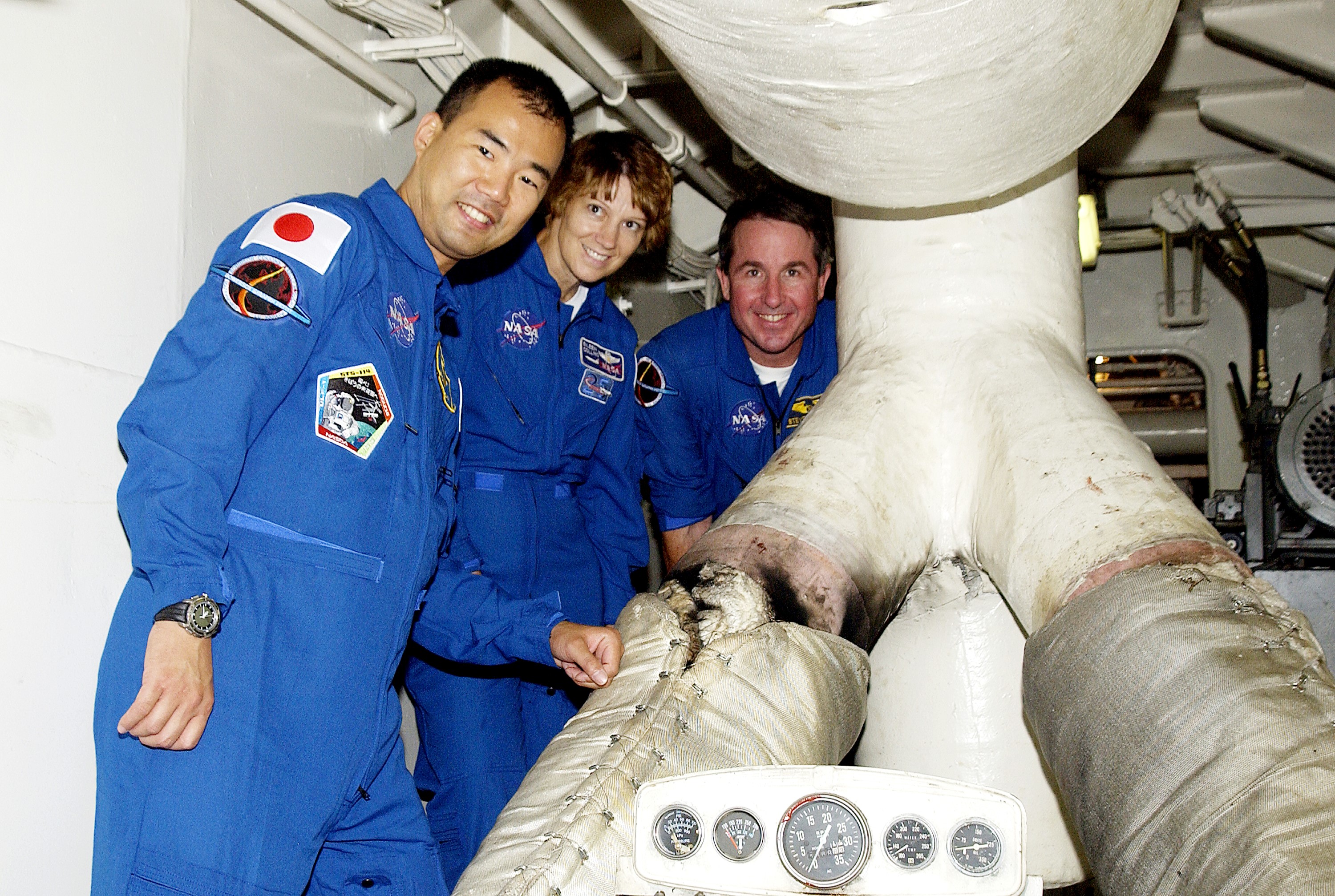 KENNEDY SPACE CENTER, FLA. - Visiting the engine room of the Liberty Star, one of two SRB Retrieval Ships, are STS-114 crew members Soichi Noguchi, mission specialist, Eileen Collins, commander, and Stephen Robinson, mission specialist. Noguchi is with the Japanese space agency NASDA. Not pictured is Pilot James Kelly. On their mission, the crew will carry the MultiPurpose Logistics Module (MPLM) Raffaello and External Stowage Platform 2 to the International Space Station. The MPLM will contain supplies and equipment. Another goal of the mission is to remove and replace a Control Moment Gyro. Launch date for mission STS-114 is under review.