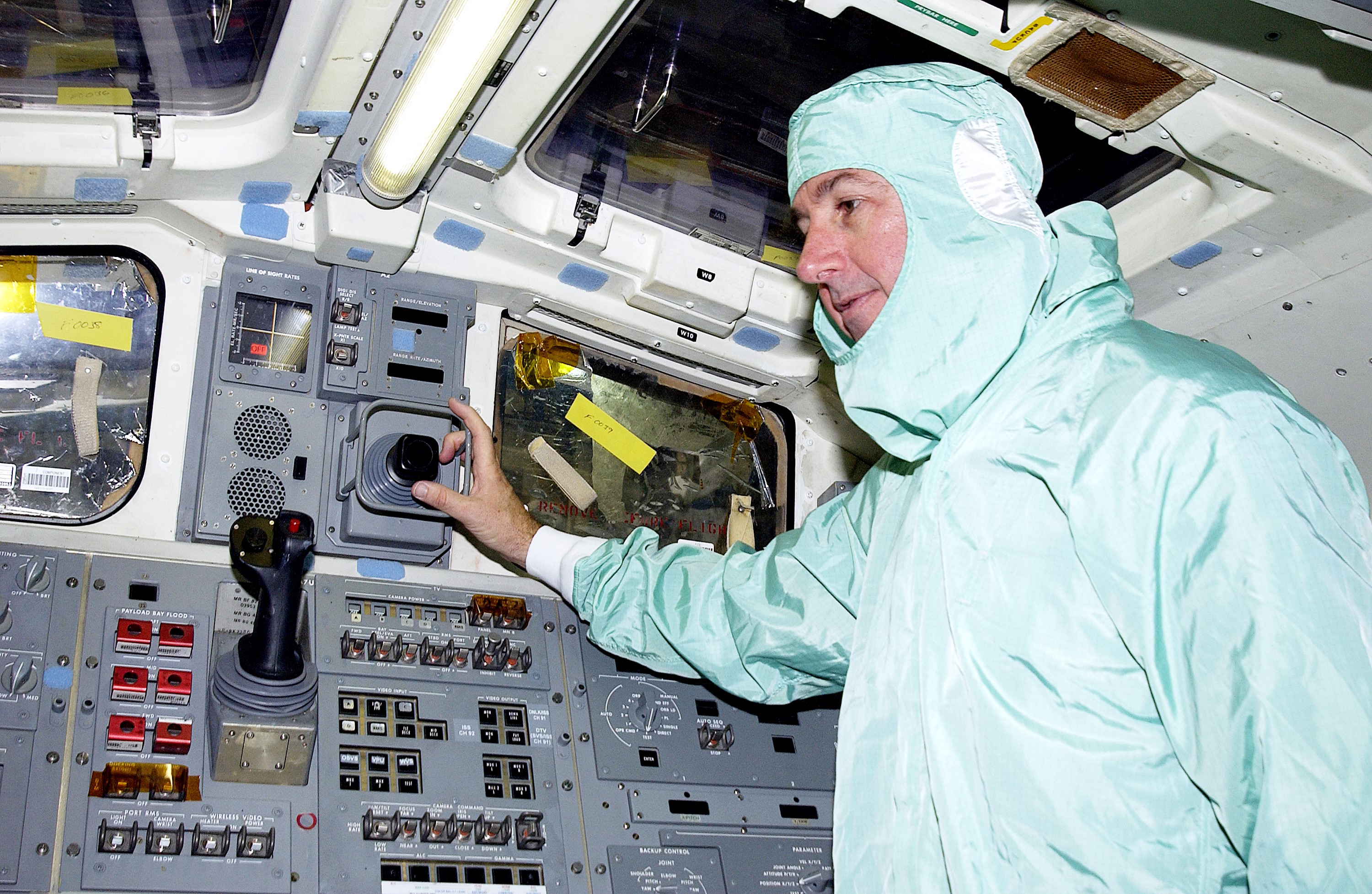 KENNEDY SPACE CENTER, FLA. - STS-114 Mission Specialist Stephen Robinson checks equipment in the flight deck of orbiter Atlantis. He and other crew members - Commander Eileen Collins, Pilot James Kelly and Mission Specialist Soichi Noguchi - are at KSC for equipment familiarization. Noguchi is with the Japanese space agency NASDA. Mission STS-114 will carry the MultiPurpose Logistics Module (MPLM) Raffaello and External Stowage Platform 2 to the International Space Station. The MPLM will contain supplies and equipment. Another goal of the mission is to remove and replace a Control Moment Gyro. Launch date for mission STS-114 is under review.