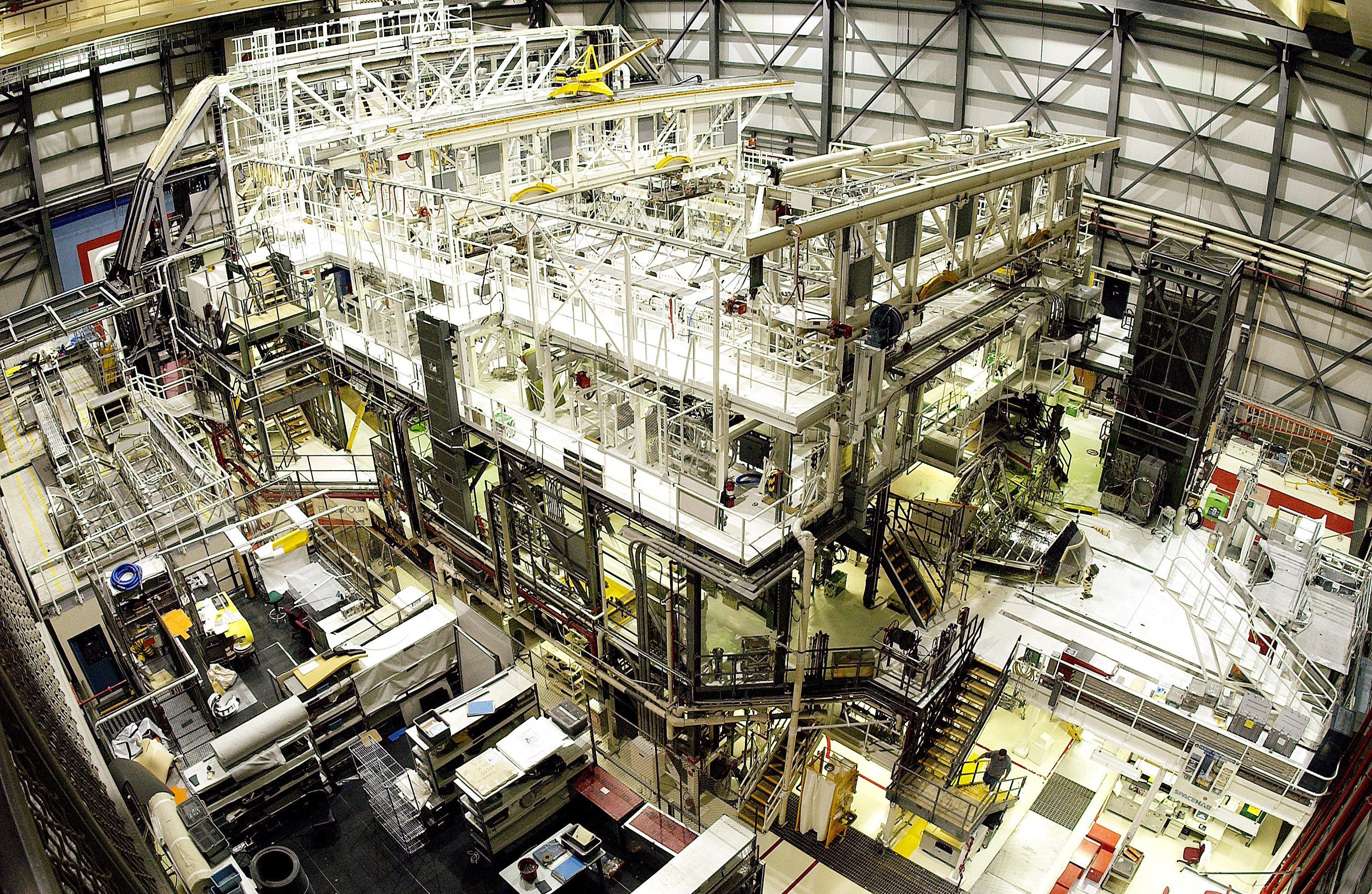 KENNEDY SPACE CENTER, FLA. - This bird's-eye view of a high bay in the Orbiter Processing Facility (OPF) shows Space Shuttle Atlantis surrounded by the standard platforms and equipment required to process a Space Shuttle orbiter for flight. The high bay is 197 feet (60 meters) long, 150 feet (46 meters) wide, 95 feet (29 meters) high, and encompasses a 29,000-square-foot (2,694-meter) area. Platforms, a main access bridge, and two rolling bridges with trucks provide access to various parts of the orbiter. The next mission scheduled for Atlantis is STS-114, a utilization and logistics flight to the International Space Station.