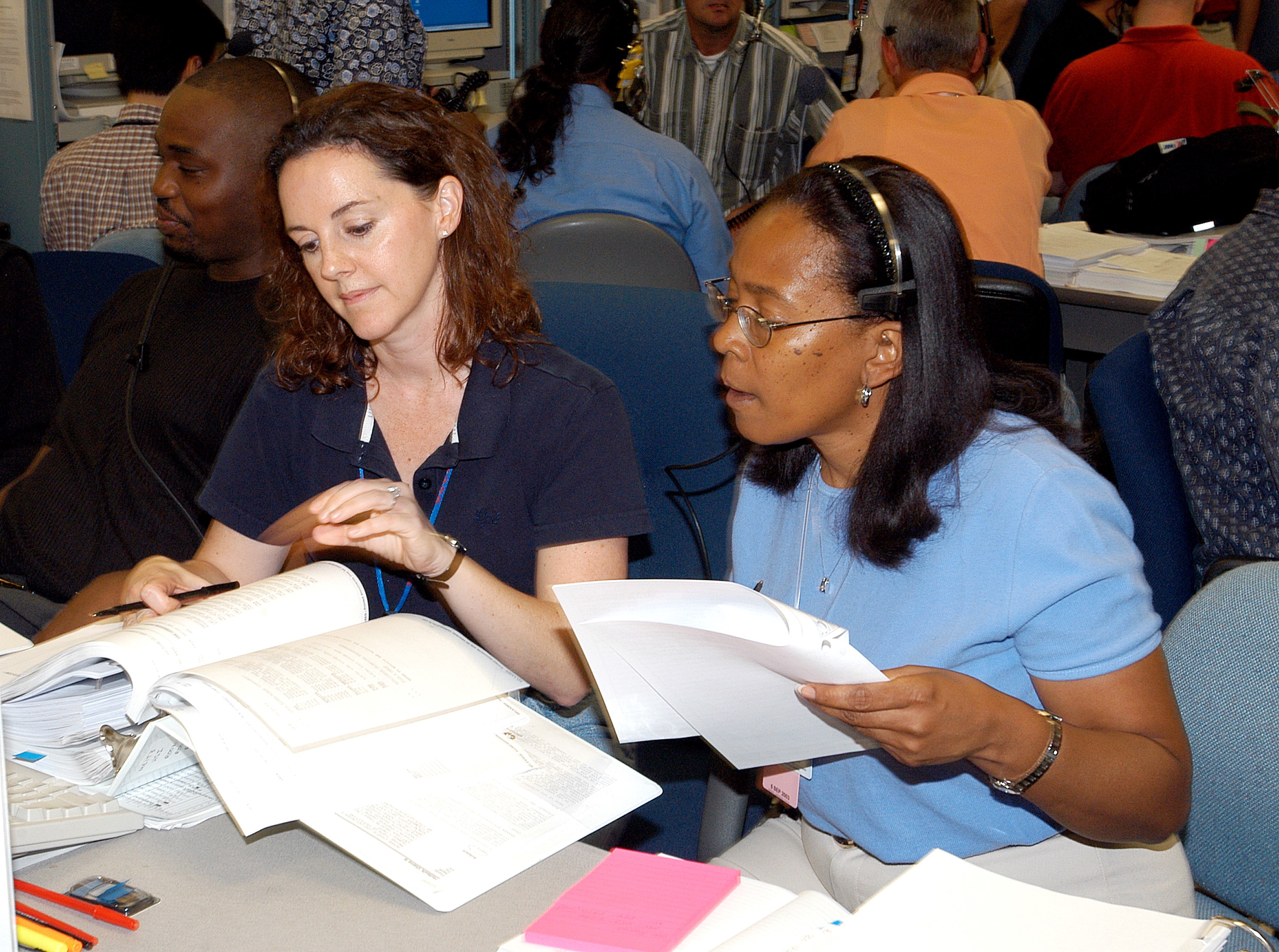 KENNEDY SPACE CENTER, FLA. - Workers in the Space Station Processing Facility look over paperwork during a Multi-Element Integrated Test (MEIT) of the U.S. Node 2 and the Japanese Experiment Module (JEM). Node 2 attaches to the end of the U.S. Lab on the ISS and provides attach locations for the Japanese laboratory, European laboratory, the Centrifuge Accommodation Module and, eventually, Multipurpose Logistics Modules. It will provide the primary docking location for the Shuttle when a pressurized mating adapter is attached to Node 2. Installation of the module will complete the U.S. Core of the ISS. The JEM, developed by the National Space Development Agency of Japan (NASDA), is Japan's primary contribution to the Station. It will enhance the unique research capabilities of the orbiting complex by providing an additional environment for astronauts to conduct science experiments.