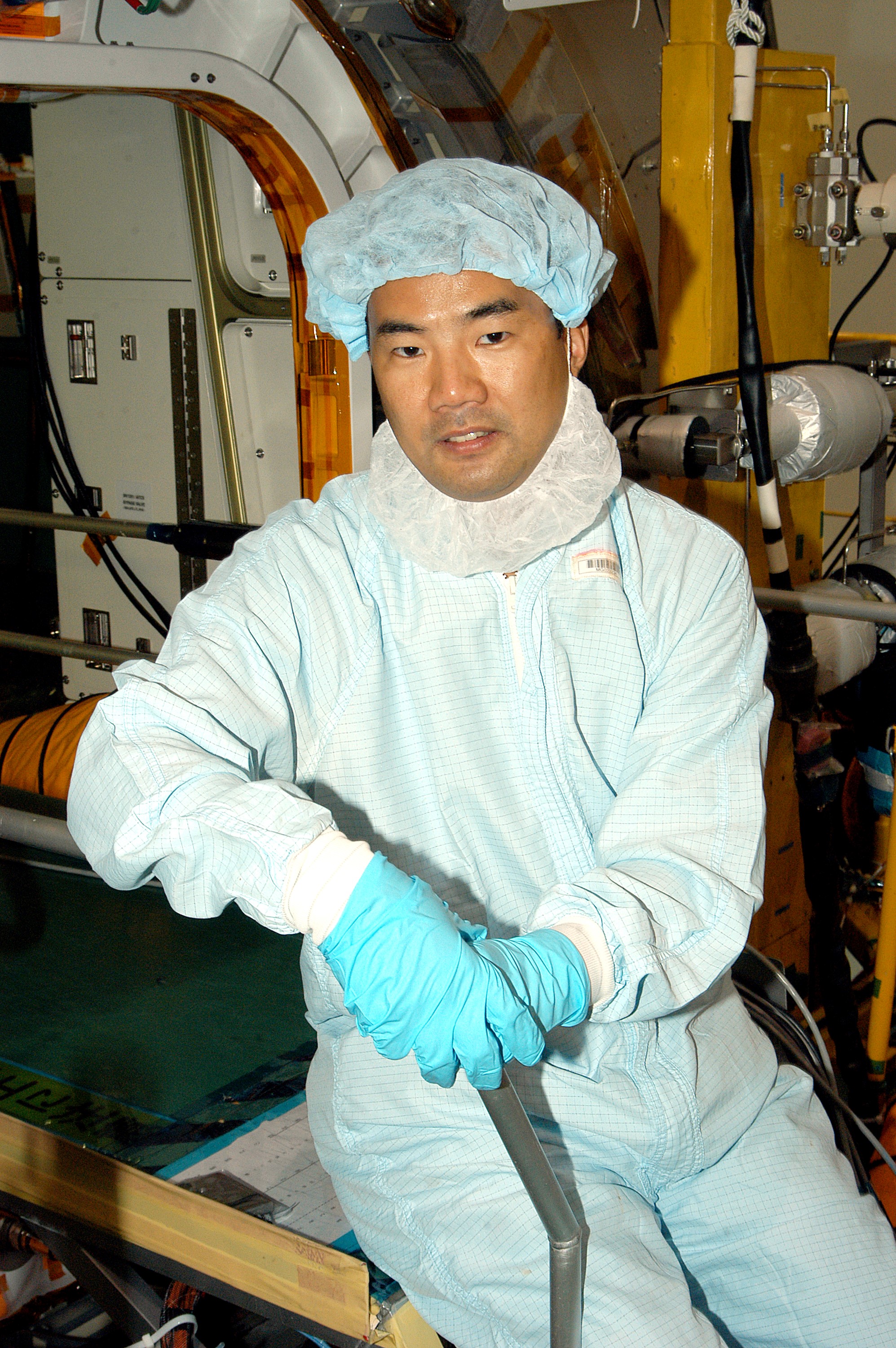 KENNEDY SPACE CENTER, FLA. - Astronaut Soichi Noguchi, with the National Space Development Agency of Japan (NASDA), rests inside the Japanese Experiment Module (JEM), undergoing a Multi-Element Integrated Test (MEIT) in the Space Station Processing Facility. Noguchi is assigned to mission STS-114 as a mission specialist. Node 2 attaches to the end of the U.S. Lab on the ISS and provides attach locations for the Japanese laboratory, European laboratory, the Centrifuge Accommodation Module and, eventually, Multipurpose Logistics Modules. It will provide the primary docking location for the Shuttle when a pressurized mating adapter is attached to Node 2. Installation of the module will complete the U.S. Core of the ISS. The JEM, developed by NASDA, is Japan's primary contribution to the Station. It will enhance the unique research capabilities of the orbiting complex by providing an additional environment for astronauts to conduct science experiments.