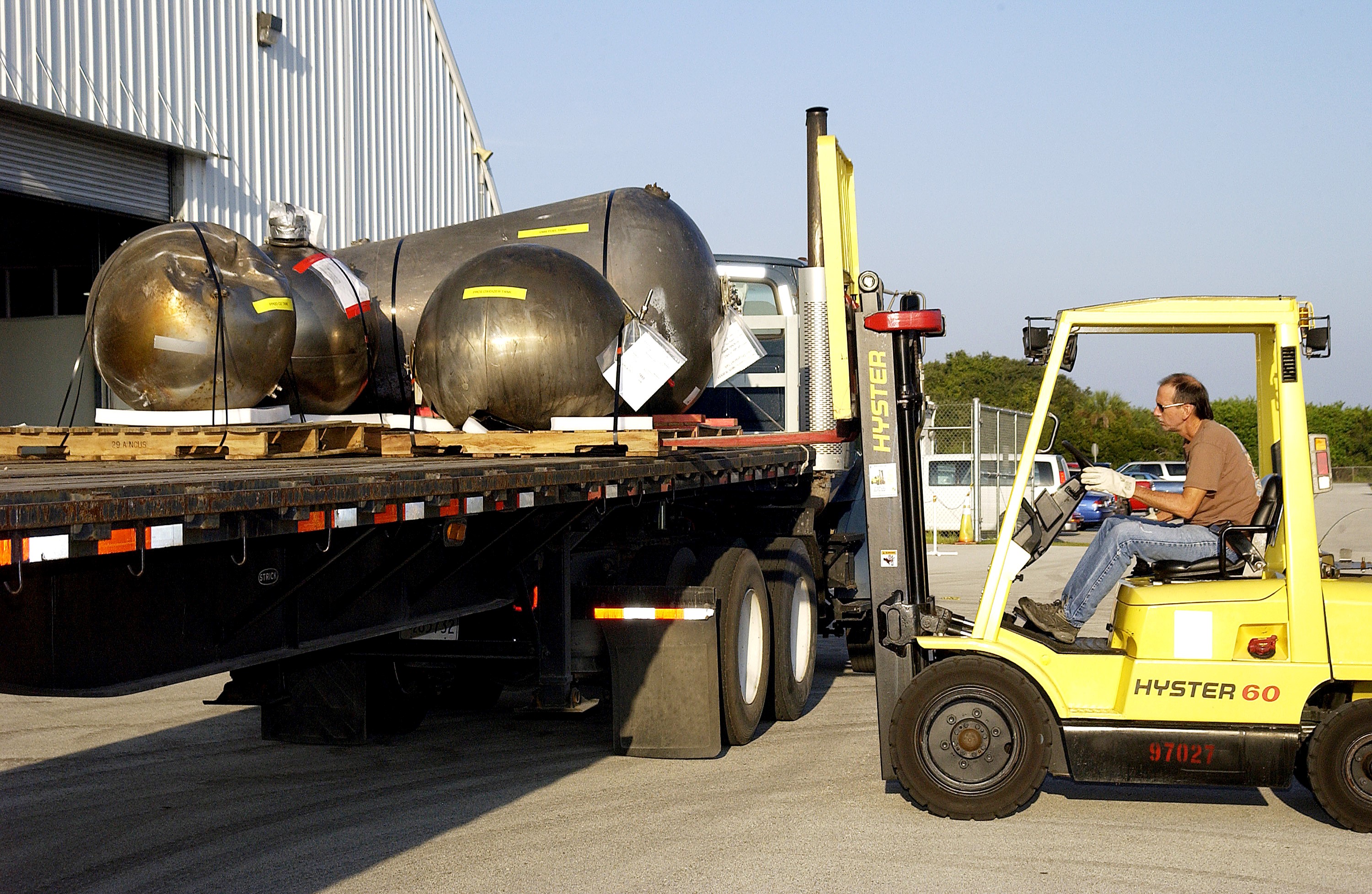 KENNEDY SPACE CENTER, FLA. - Some of the Columbia debris is loaded onto a flatbed truck outside the Columbia Debris Hangar. The debris is being transferred to the Vehicle Assembly Building for permanent storage. More than 83,000 pieces of debris were shipped to KSC during search and recovery efforts in East Texas. That represents about 38 percent of the dry weight of Columbia, equaling almost 85,000 pounds.