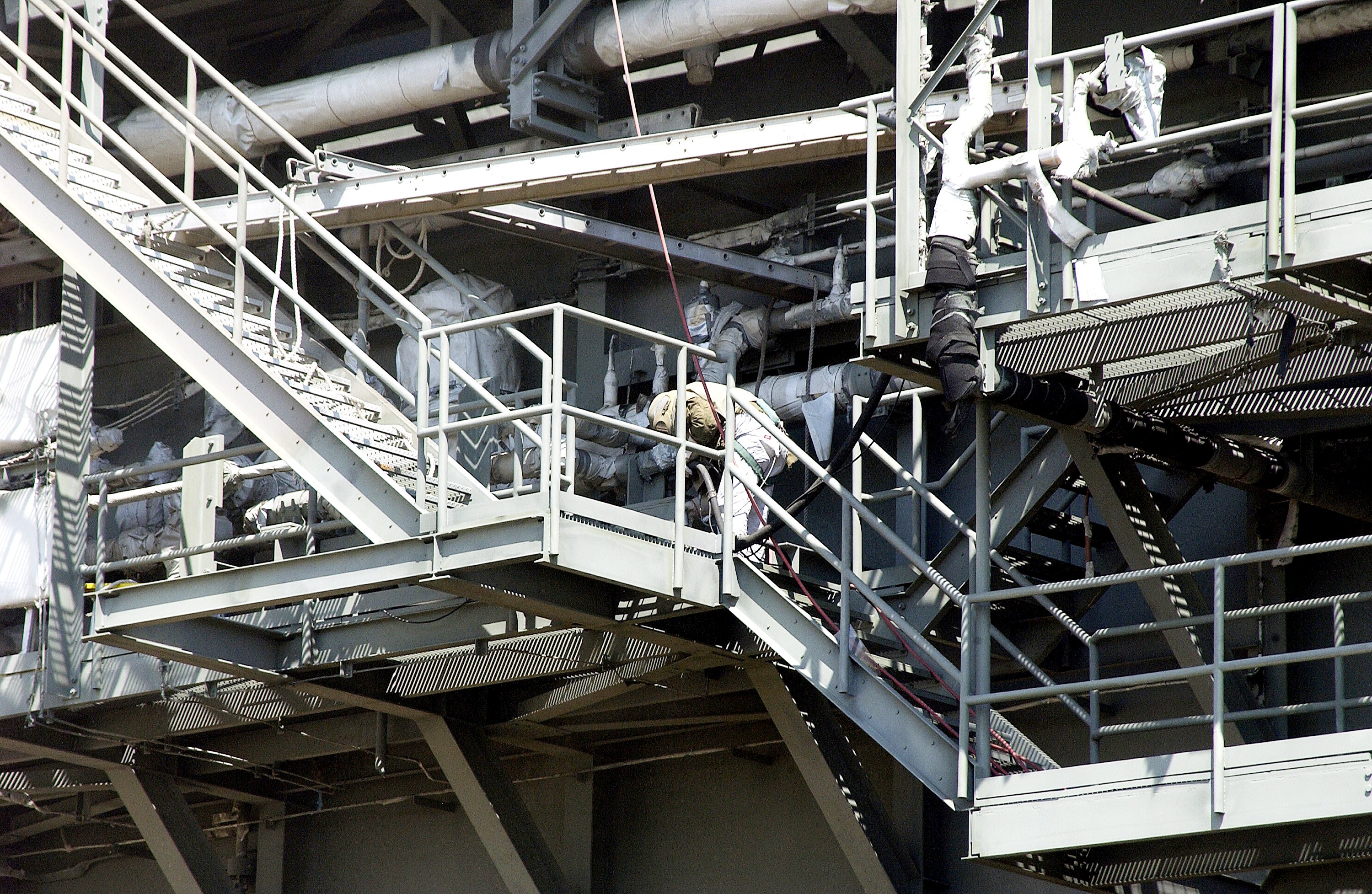 KENNEDY SPACE CENTER, FLA. - Workers, covered in protective clothing and breathing apparatus, continue sandblasting on the Mobile Launcher Platform on Launch Pad 39A to remove corrosion before repainting. Routine maintenance includes sandblasting and repainting as preventive means to minimize corrosion.