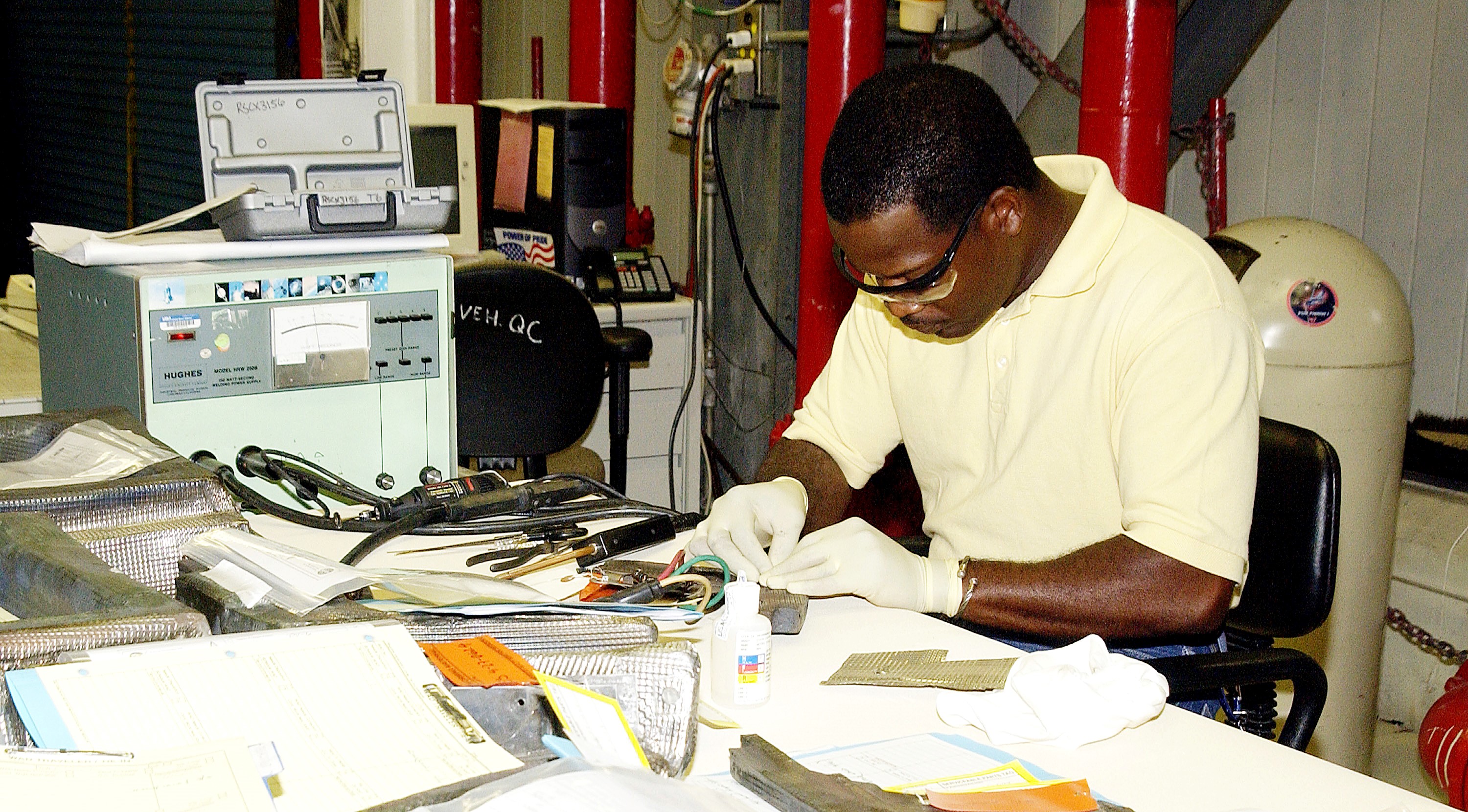 KENNEDY SPACE CENTER, FLA. - United Space Alliance employee Anthony Simmons prepares to electroweld a crack found on an insulator inside a Reinforced Carbon Carbon panel. The gray carbon composite RCC panels are attached to the leading edge of the wing of the orbiters to withstand the aerodynamic forces experienced during launch and reentry, which can reach as high as 800 pounds per square foot. The operating range of RCC is from minus 250º F to about 3,000º F, the temperature produced by friction with the atmosphere during reentry.