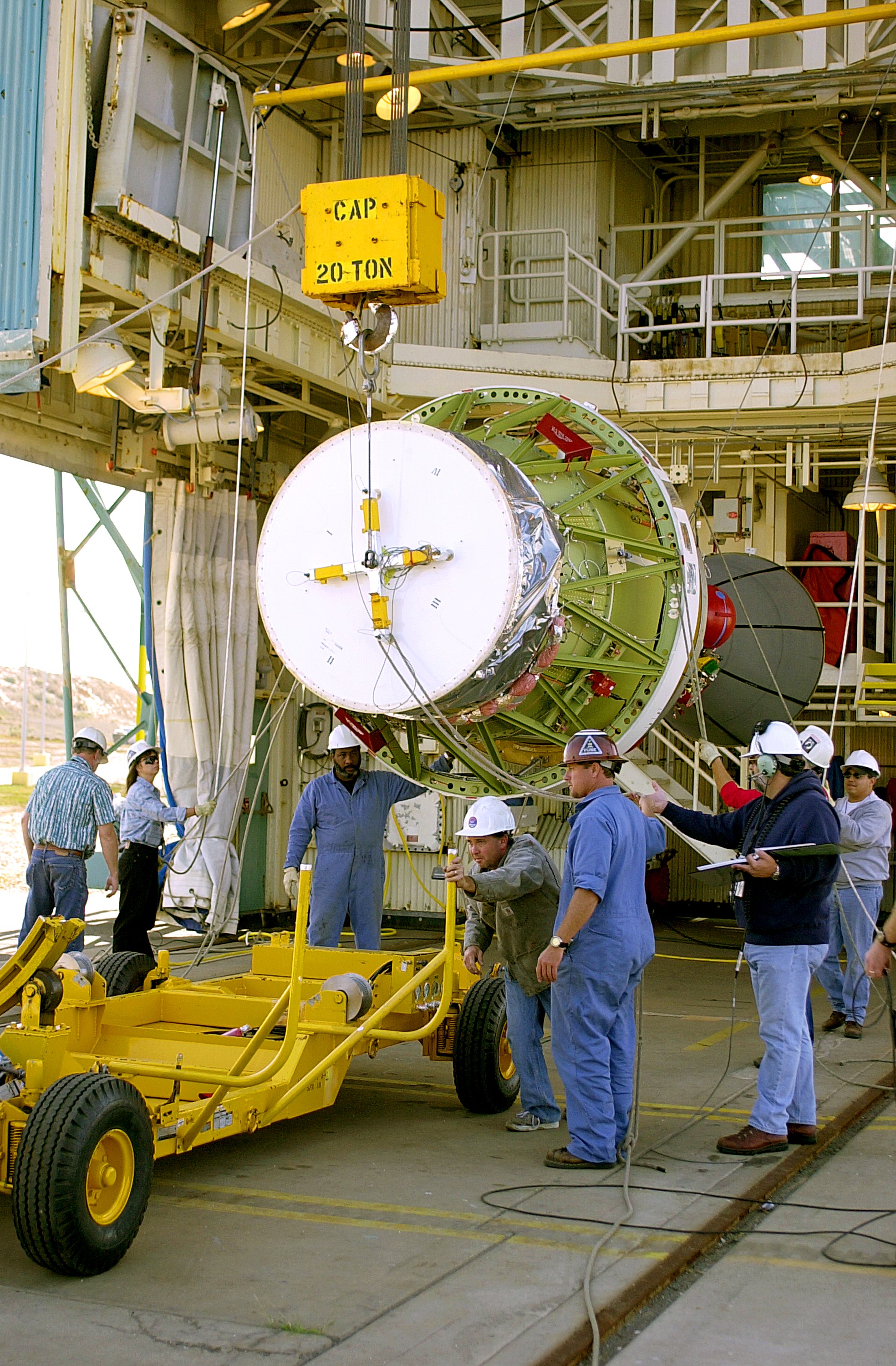 VANDENBERG AFB, CALIF. - The second stage of the Delta II launch vehicle for the Gravity Probe B experiment is lifted off the transporter after its arrival on Space Launch Complex 2, Vandenberg Air Force Base, Calif. The Gravity Probe B will launch a payload of four gyroscopes into low-Earth polar orbit to test two extraordinary predictions of Albert Einstein’s general theory of relativity: the geodetic effect (how space and time are warped by the presence of the Earth) and frame dragging (how Earth’s rotation drags space and time around with it). Once in orbit, for 18 months each gyroscope’s spin axis will be monitored as it travels through local spacetime, observing and measuring these effects. The experiment was developed by Stanford University, Lockheed Martin and NASA’s Marshall Space Flight Center. The targeted launch date is Dec. 6, 2003.