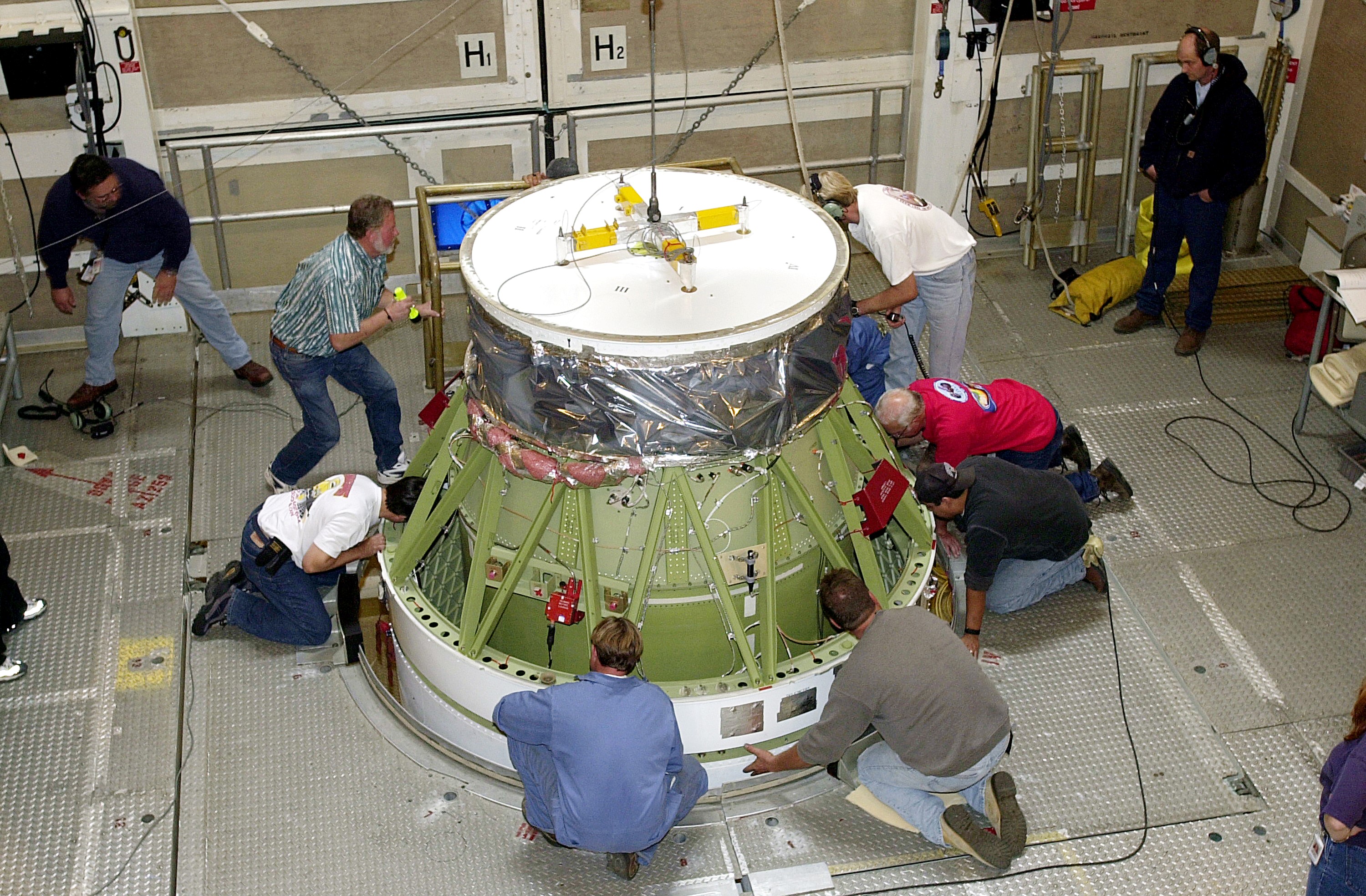 VANDENBERG AFB, CALIF. - Workers on the mobile service tower at Space Launch Complex 2, Vandenberg Air Force Base, Calif., check the Delta II rocket’s second stage as it is mated with the first stage. The Delta II is the launch vehicle for the Gravity Probe B experiment, developed by Stanford University, Lockheed Martin and NASA’s Marshall Space Flight Center. The Gravity Probe B will launch a payload of four gyroscopes into low-Earth polar orbit to test two extraordinary predictions of Albert Einstein’s general theory of relativity: the geodetic effect (how space and time are warped by the presence of the Earth) and frame dragging (how Earth’s rotation drags space and time around with it). Once in orbit, for 18 months each gyroscope’s spin axis will be monitored as it travels through local spacetime, observing and measuring these effects. The targeted launch date is Dec. 6, 2003.