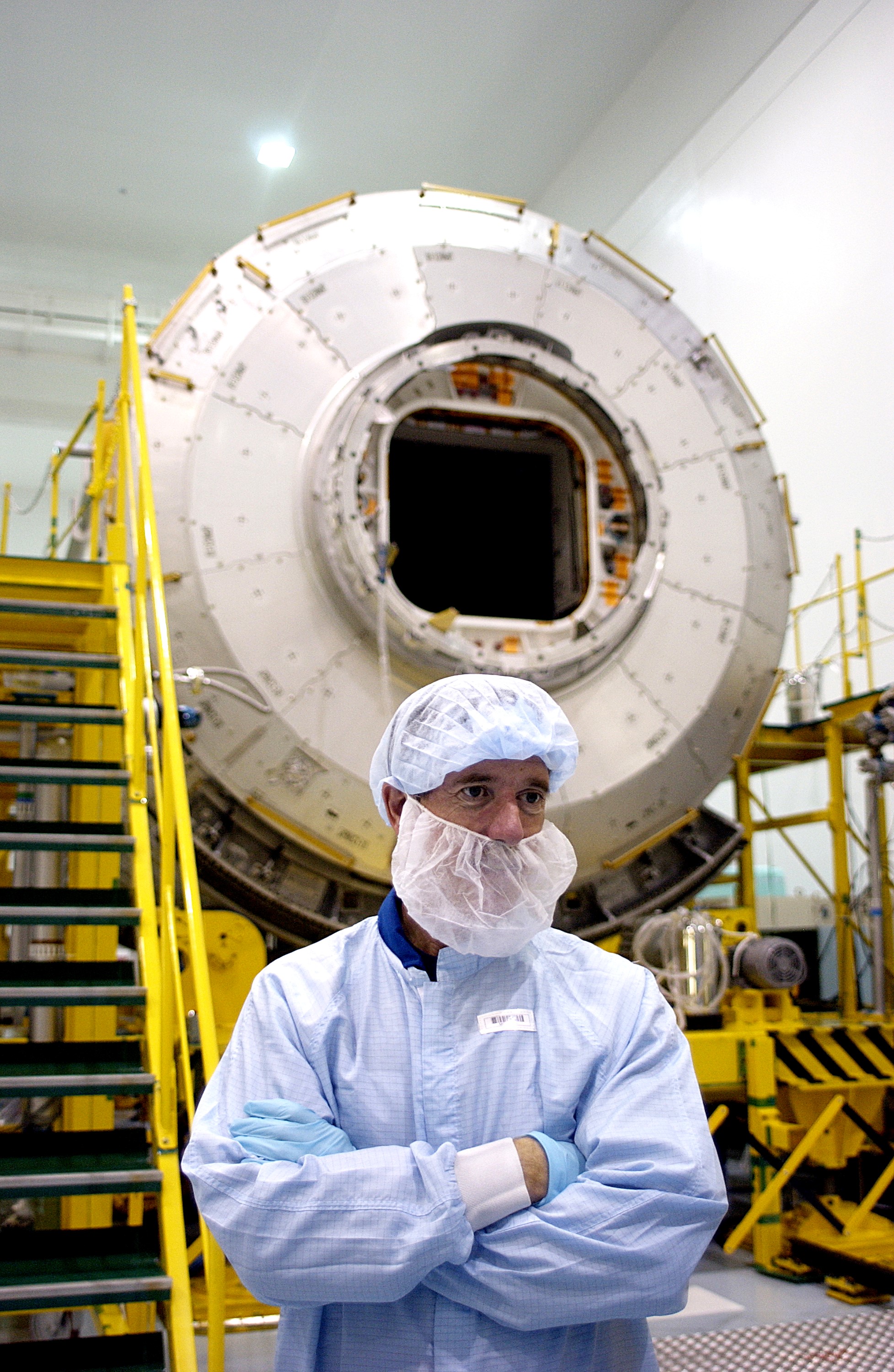 KENNEDY SPACE CENTER, FLA. - In the Space Station Processing Facility, STS-117 Mission Specialist James Reilly stands in front of the Japanese Experiment Module (JEM). Reilly and STS-115 Mission Specialist Joseph Tanner are at KSC for equipment familiarization, a routine part of astronaut training and launch preparations.
