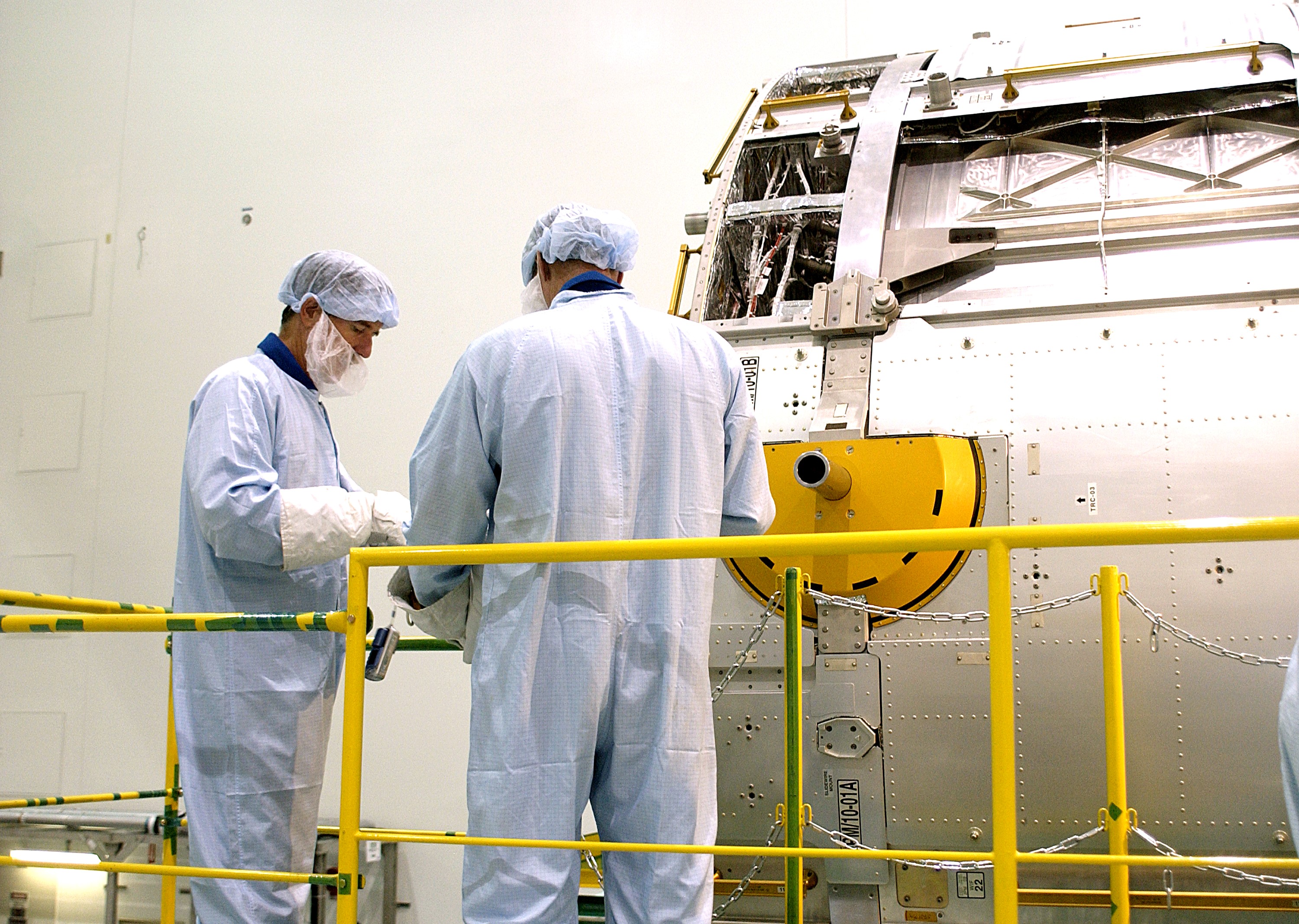 KENNEDY SPACE CENTER, FLA. - In the Space Station Processing Facility, STS-117 Mission Specialist James Reilly (left) and STS-115 Mission Specialist Joseph Tanner get hands-on experience with the Japanese Experiment Module (JEM). Reilly and Tanner are at KSC for equipment familiarization, a routine part of astronaut training and launch preparations.