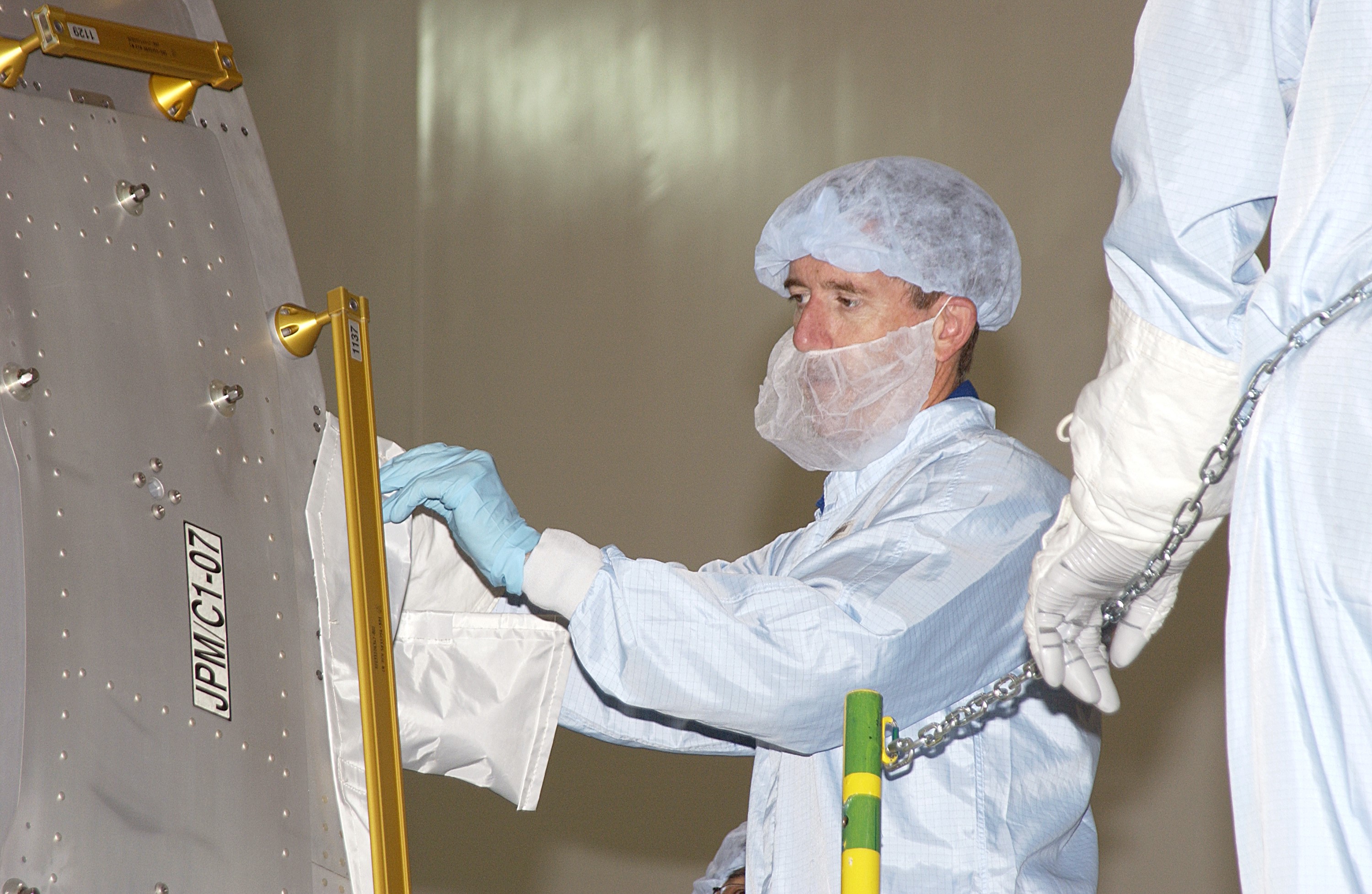 KENNEDY SPACE CENTER, FLA. - In the Space Station Processing Facility, STS-117 Mission Specialist James Reilly works with the Japanese Experiment Module (JEM). Reilly and STS-115 Mission Specialist Joseph Tanner are at KSC for equipment familiarization, a routine part of astronaut training and launch preparations.